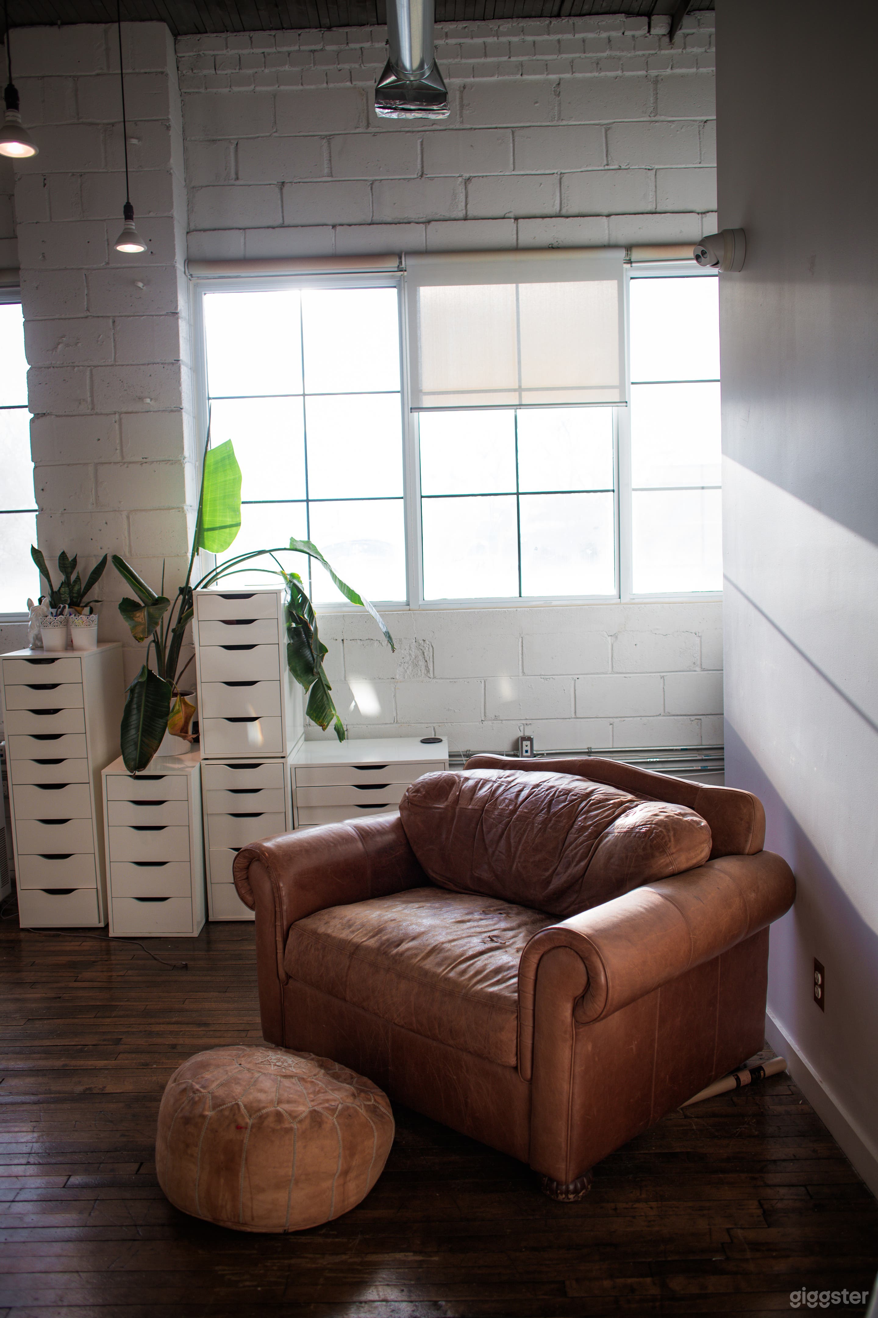 Natural light loft, exposed brick, industrial look, sunlight photography studio, golden hour 