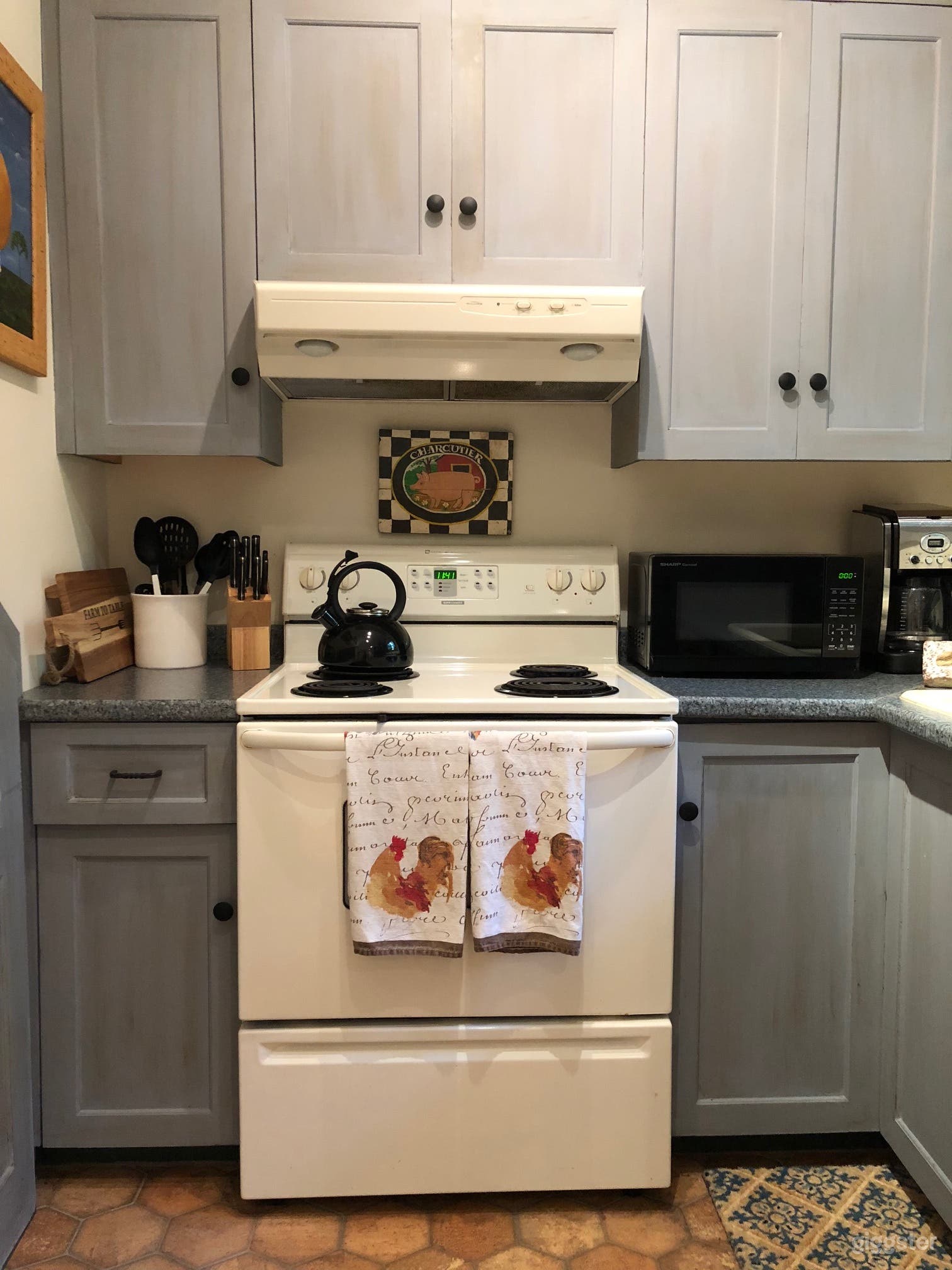 Kitchen with hand-painted wood cabinets. 