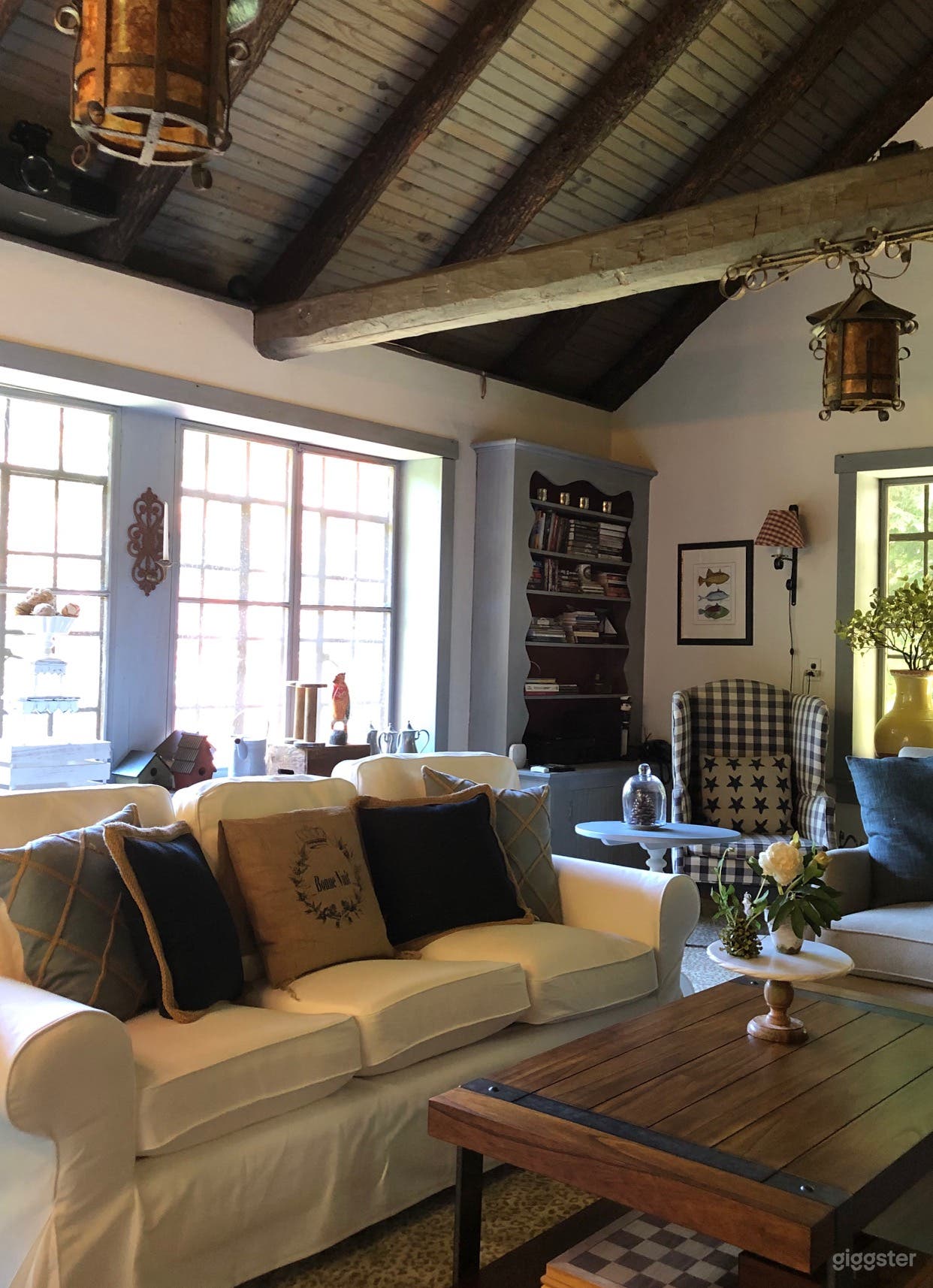 This view of the Great Room highlights the beamed ceilings and original lighting fixtures. All trim has been brush-painted by the owner. 