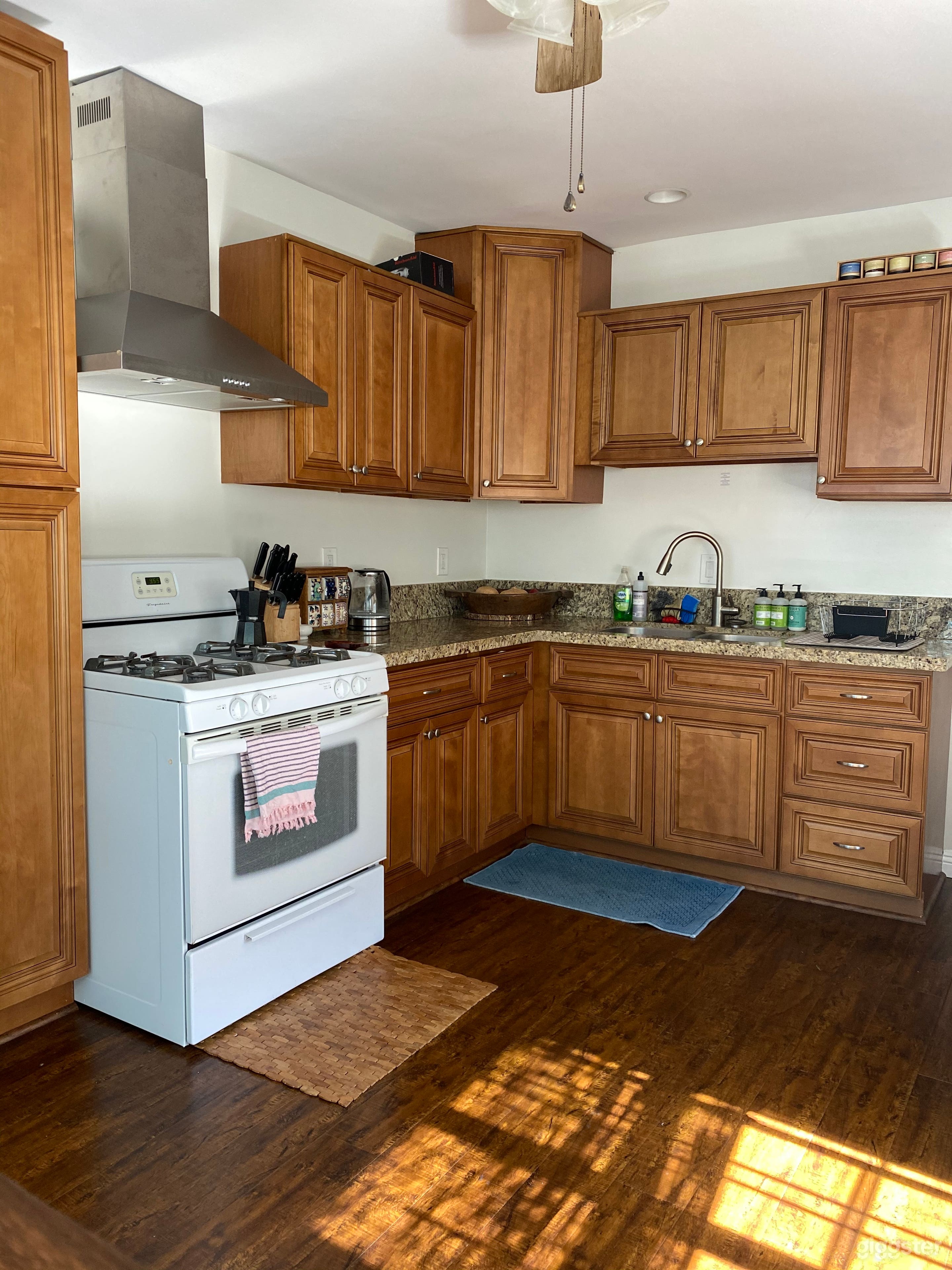Off white wall with light light brown kitchen cabinets. 