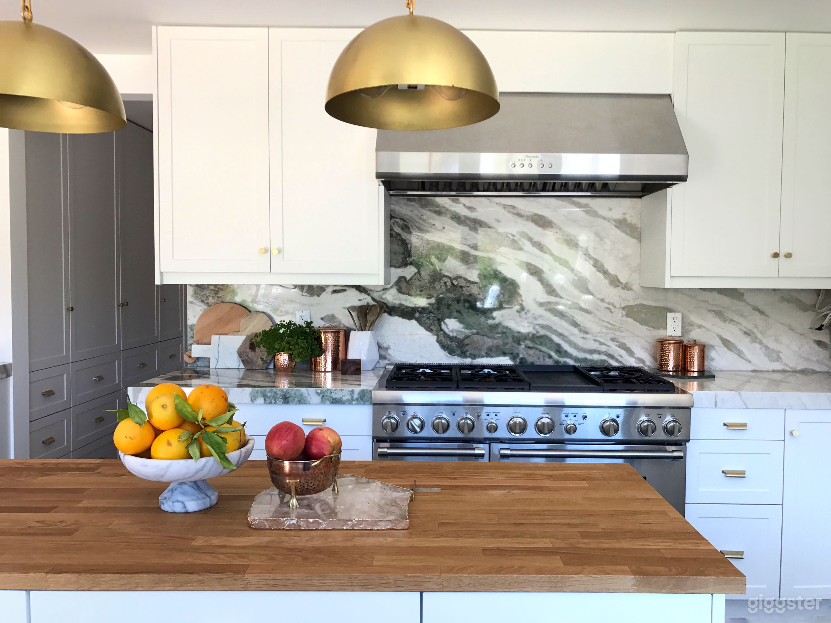 Kitchen island, green tweed marble backsplash, and brass fixtures. Excellent light from 3 directions
