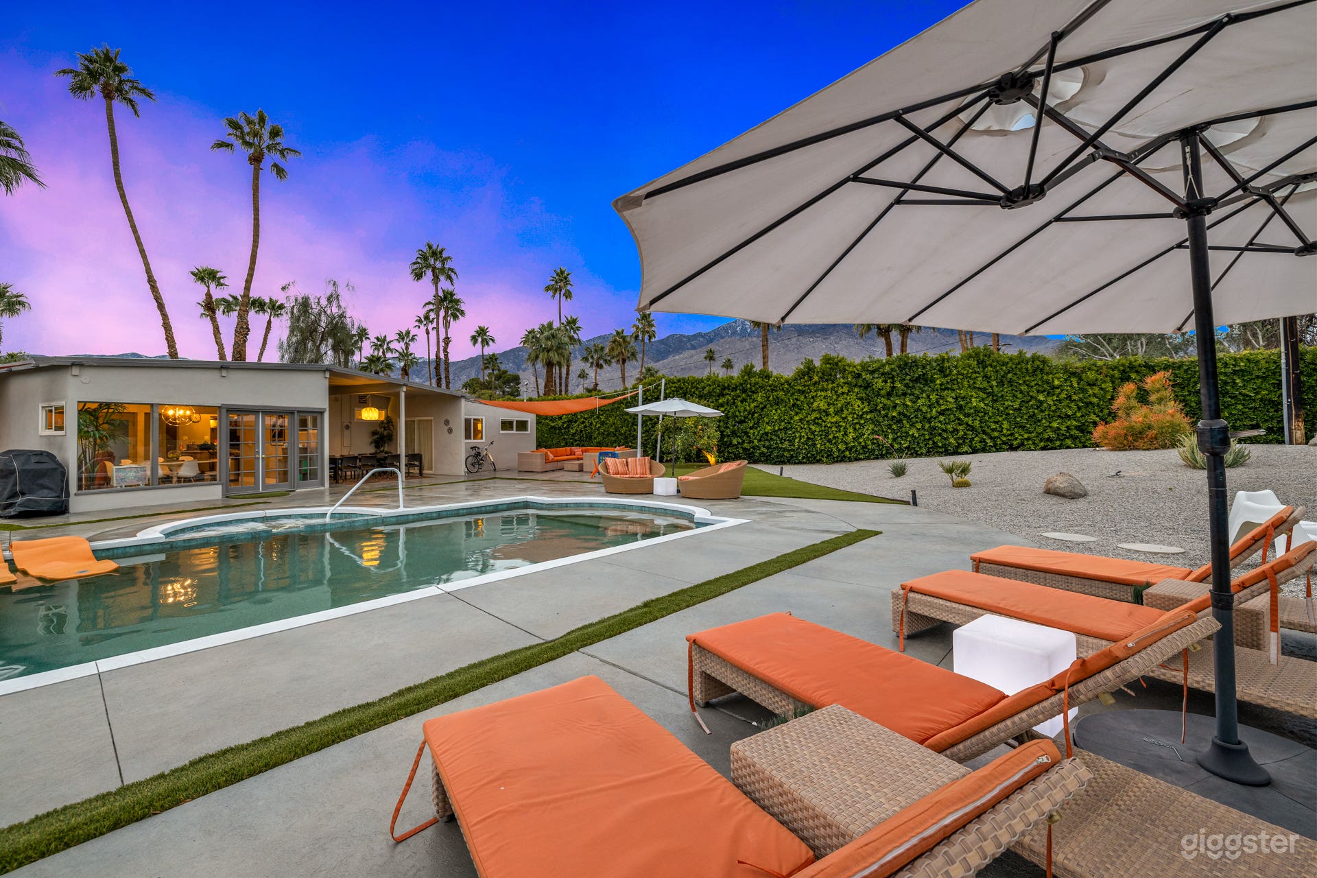 Iconic Dedon Loungers and Daybeds frame the salt water pool