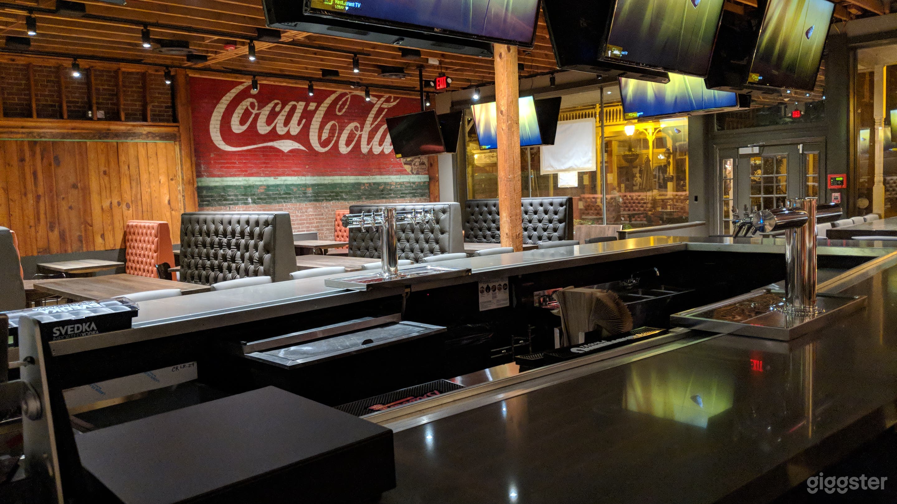 Large bar area, surrounded by high back booths.