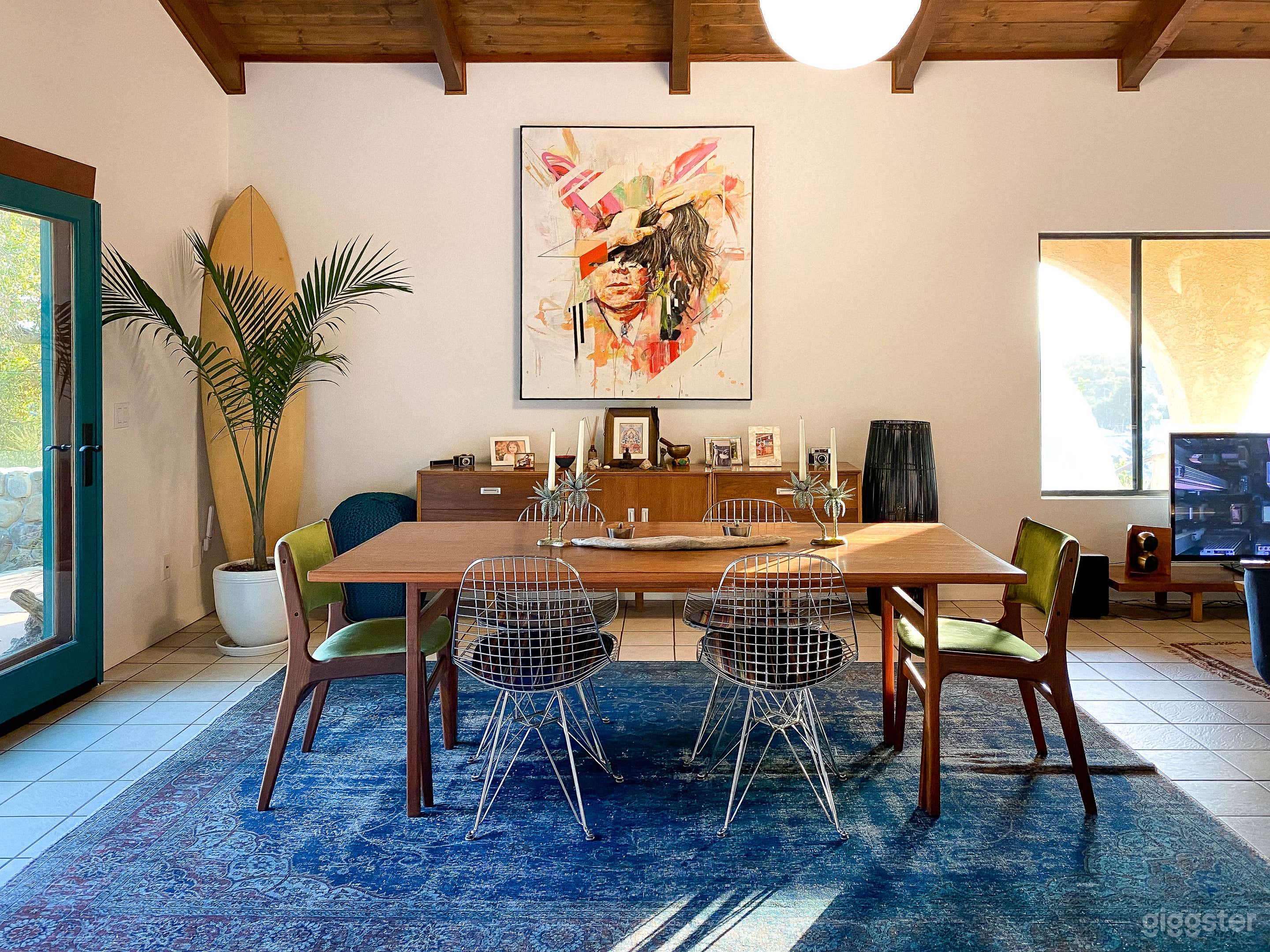 Living room of The Meiner Airbnb and video shoot location in Ojai, California featuring mid century surf inspired boho decor looking at the dining area.