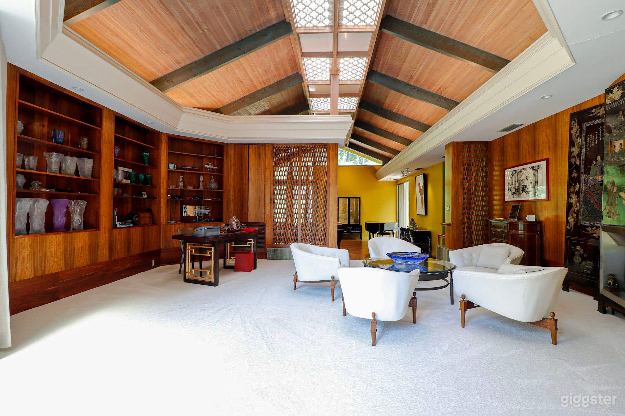 Elevated room with glass wall, crotched mahogany walls, coromandel screen, quatrefoil skylights, cypress ceiling