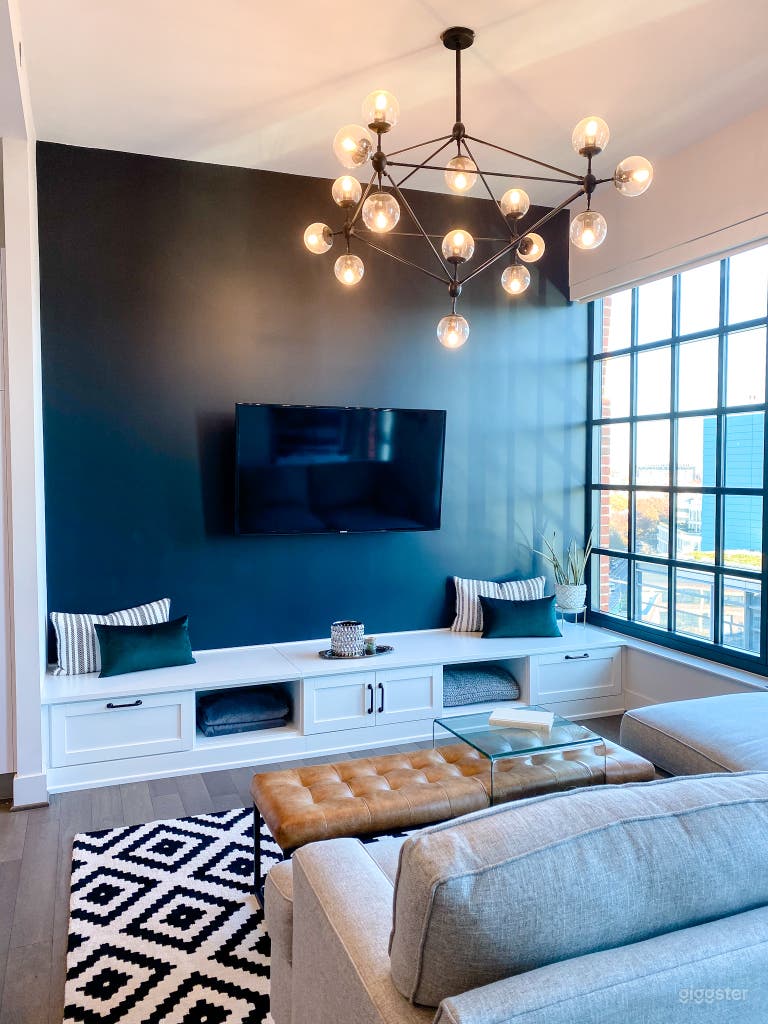  Main living space with large windows and single black wall behind TV 