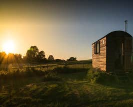 16&#x27; Hut in paddock at sunset 