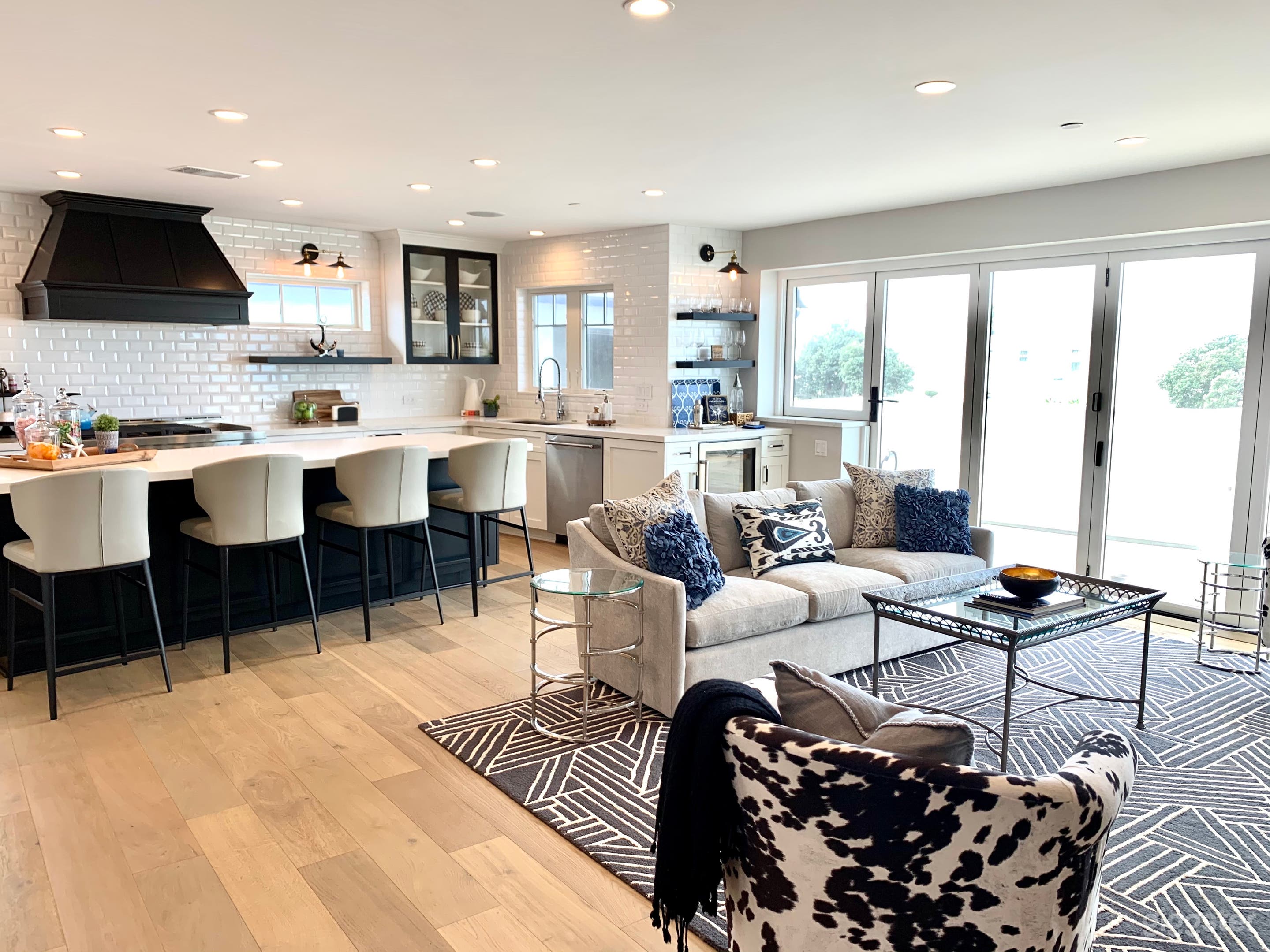 Open gourmet kitchen and living room.  Catalina glass floor to ceiling windows open onto a patio