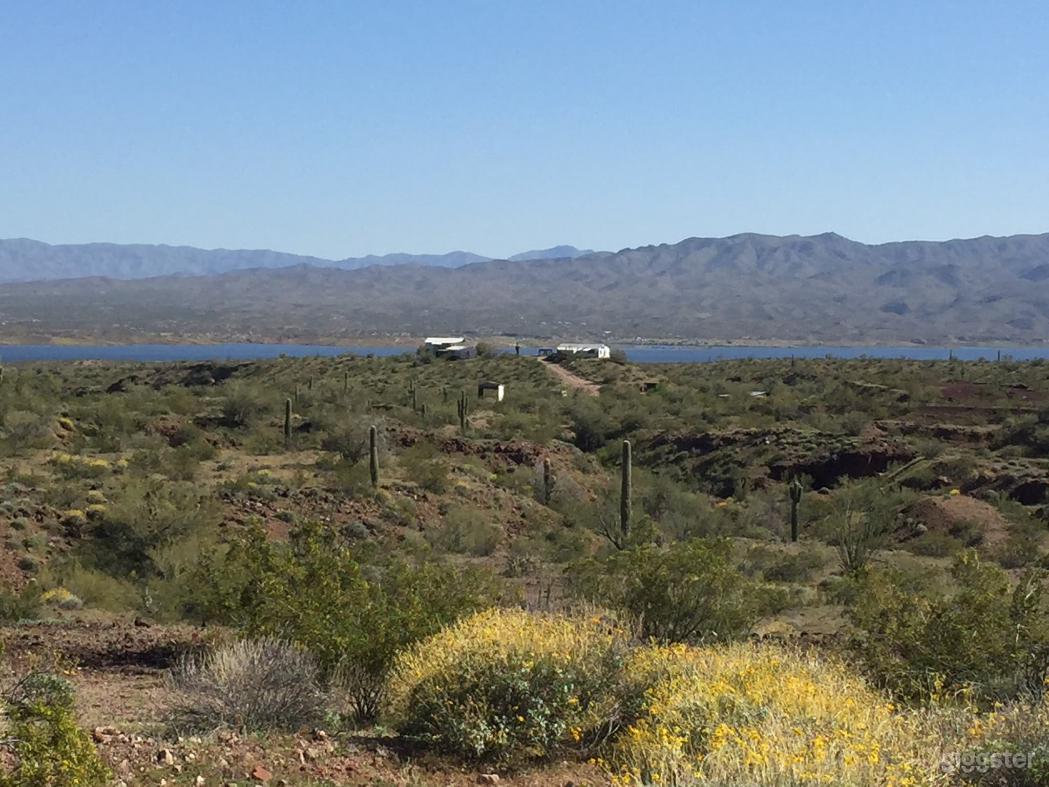 Two unrestored houses sit in a hill over looking Alamo Lake