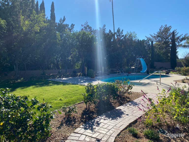  Charming pool complete with a slide and diving board 