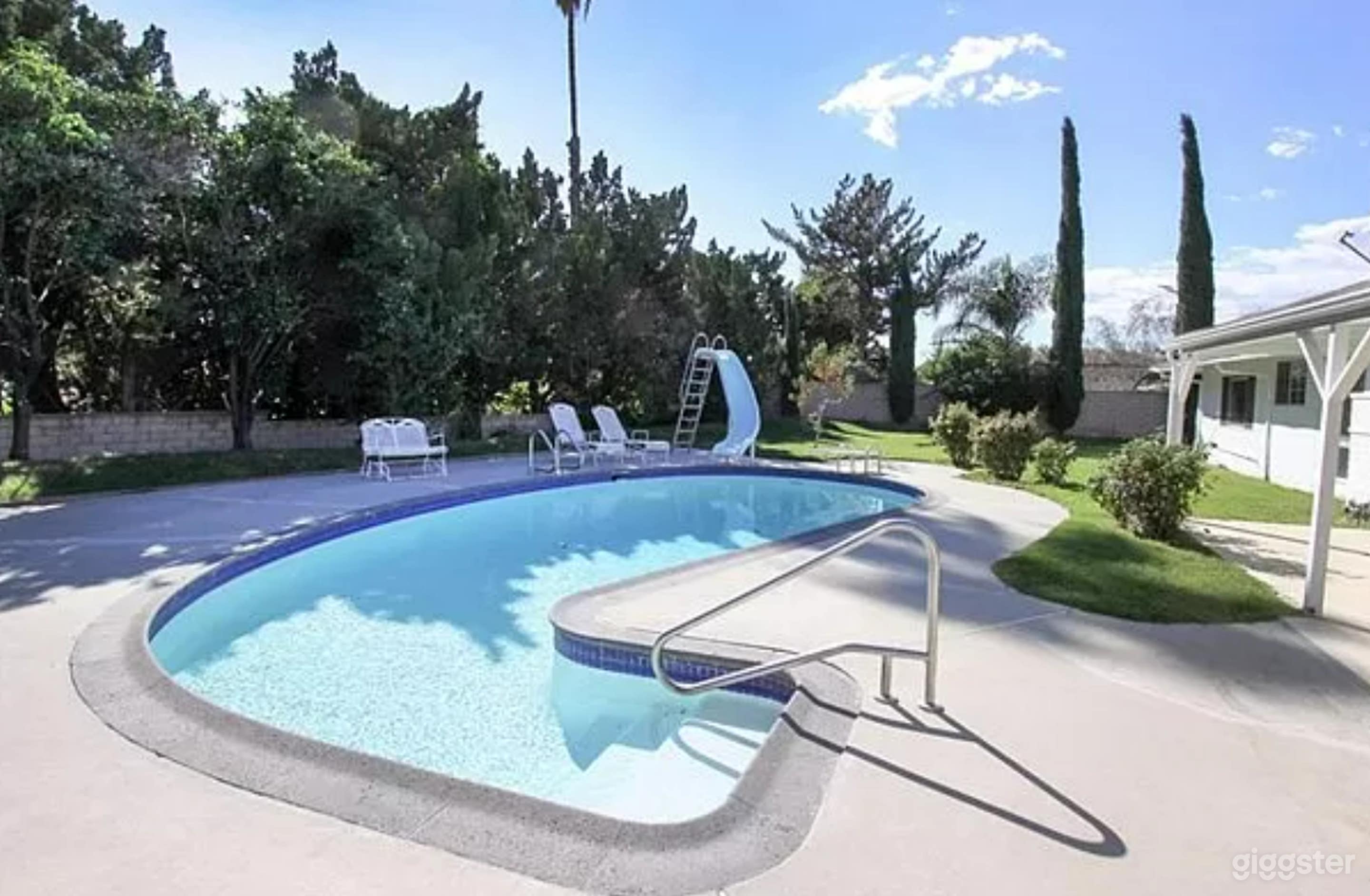 Charming pool complete with a slide and diving board Photo 1