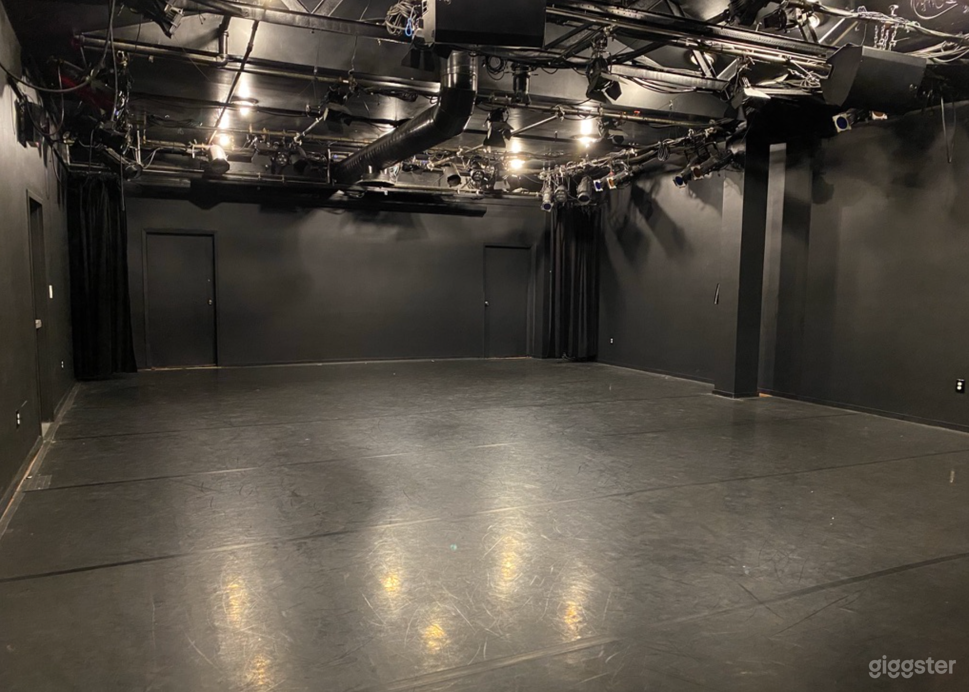 Image of our black box theater, with a marley floor.