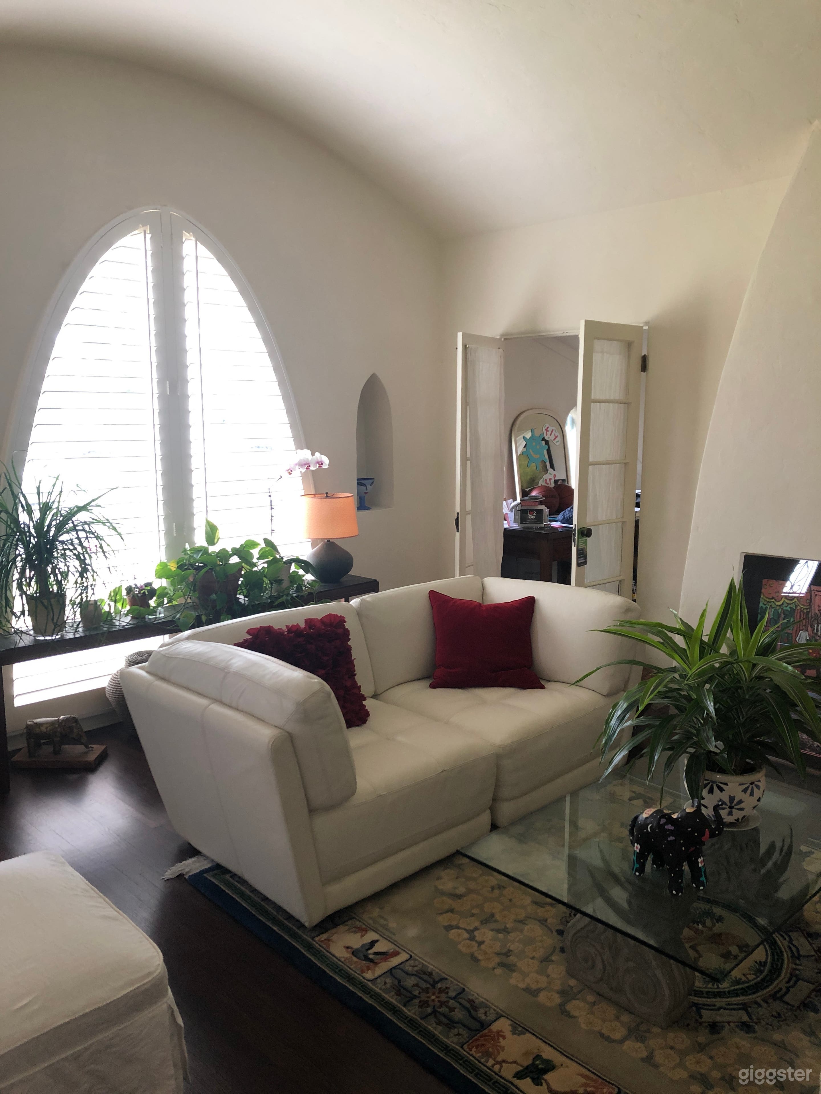 House was built in 1929 and is an original Spanish stucco home - updated 3 years ago but kept the original amenities, windows, and details for authentic charm.  Living room view from dining area/second living area.  Open door is an office area, not avail. 