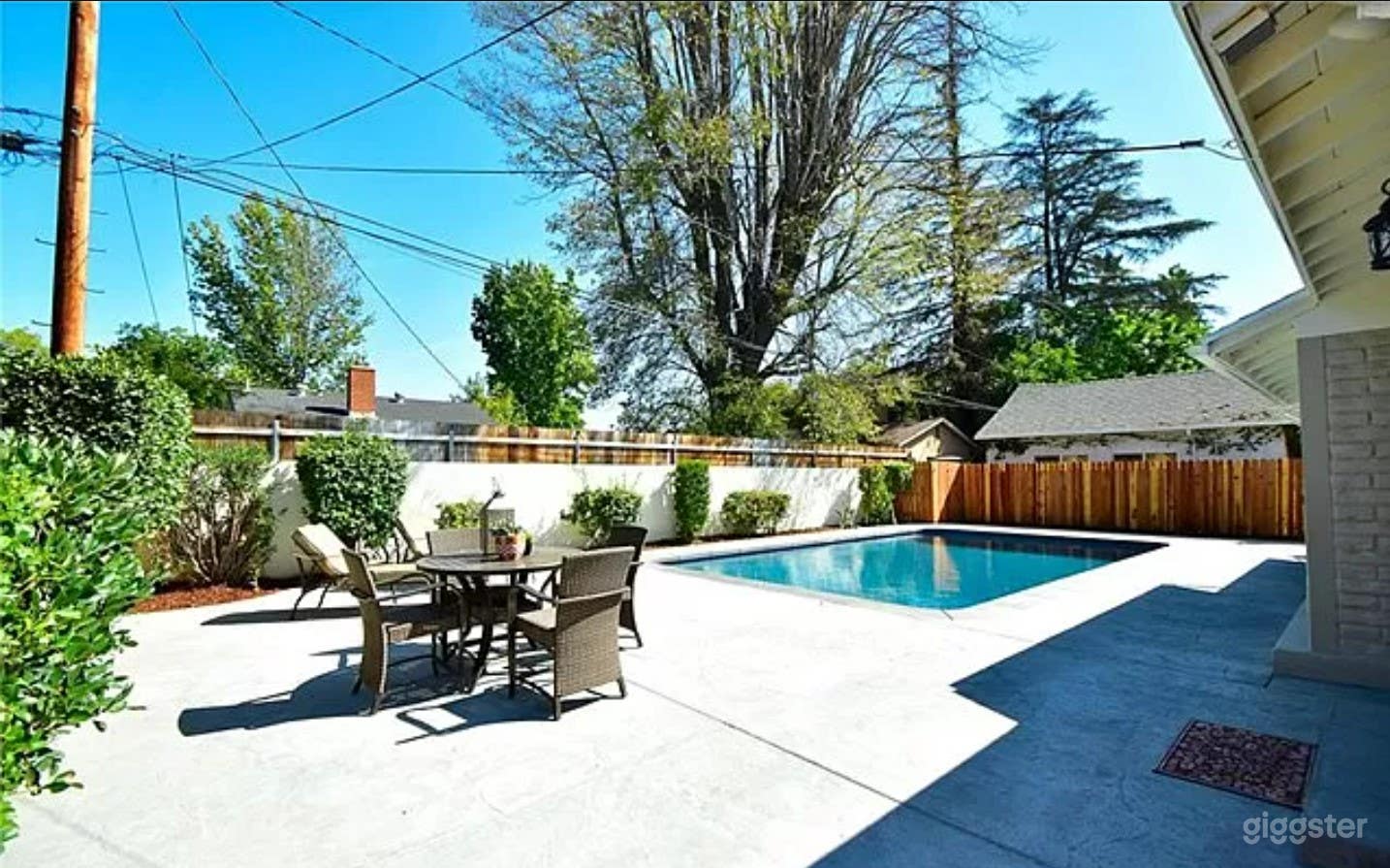 A Stunning pool area in a single-story residence Photo 3