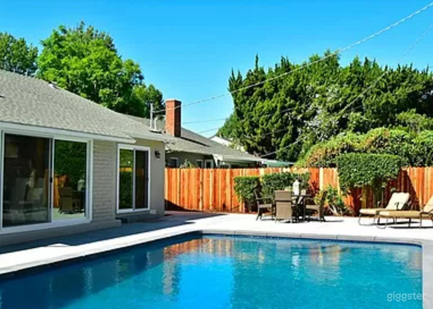 A Stunning pool area in a single-story residence Photo 4