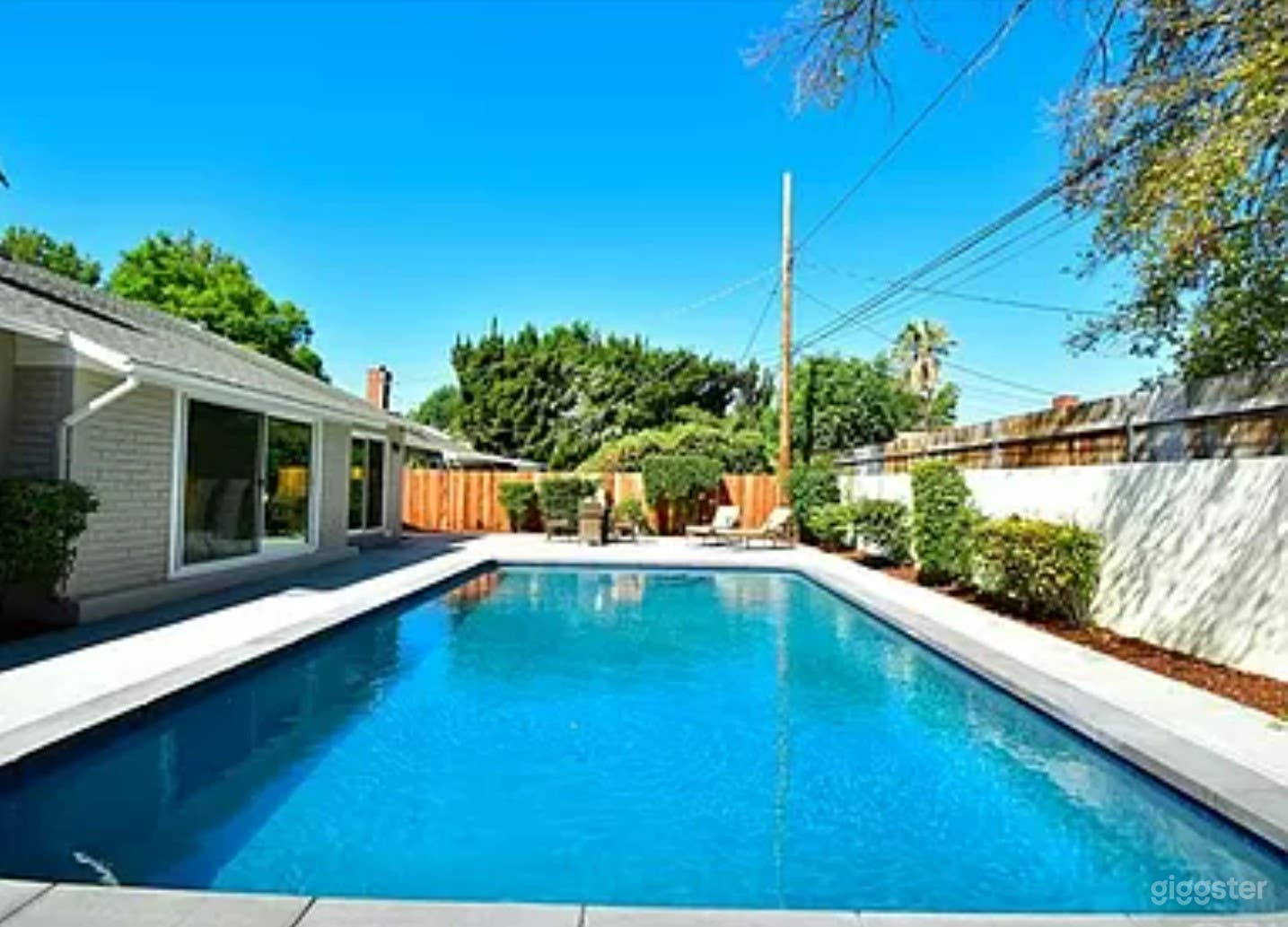 A Stunning pool area in a single-story residence Photo 2