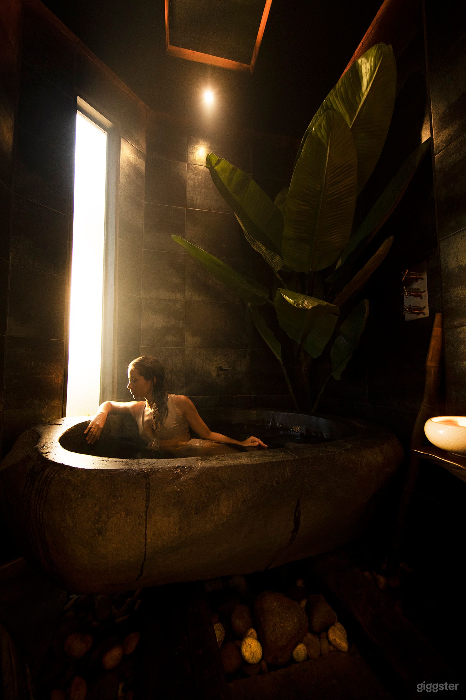 Balinese stone soaking tub with rain shower