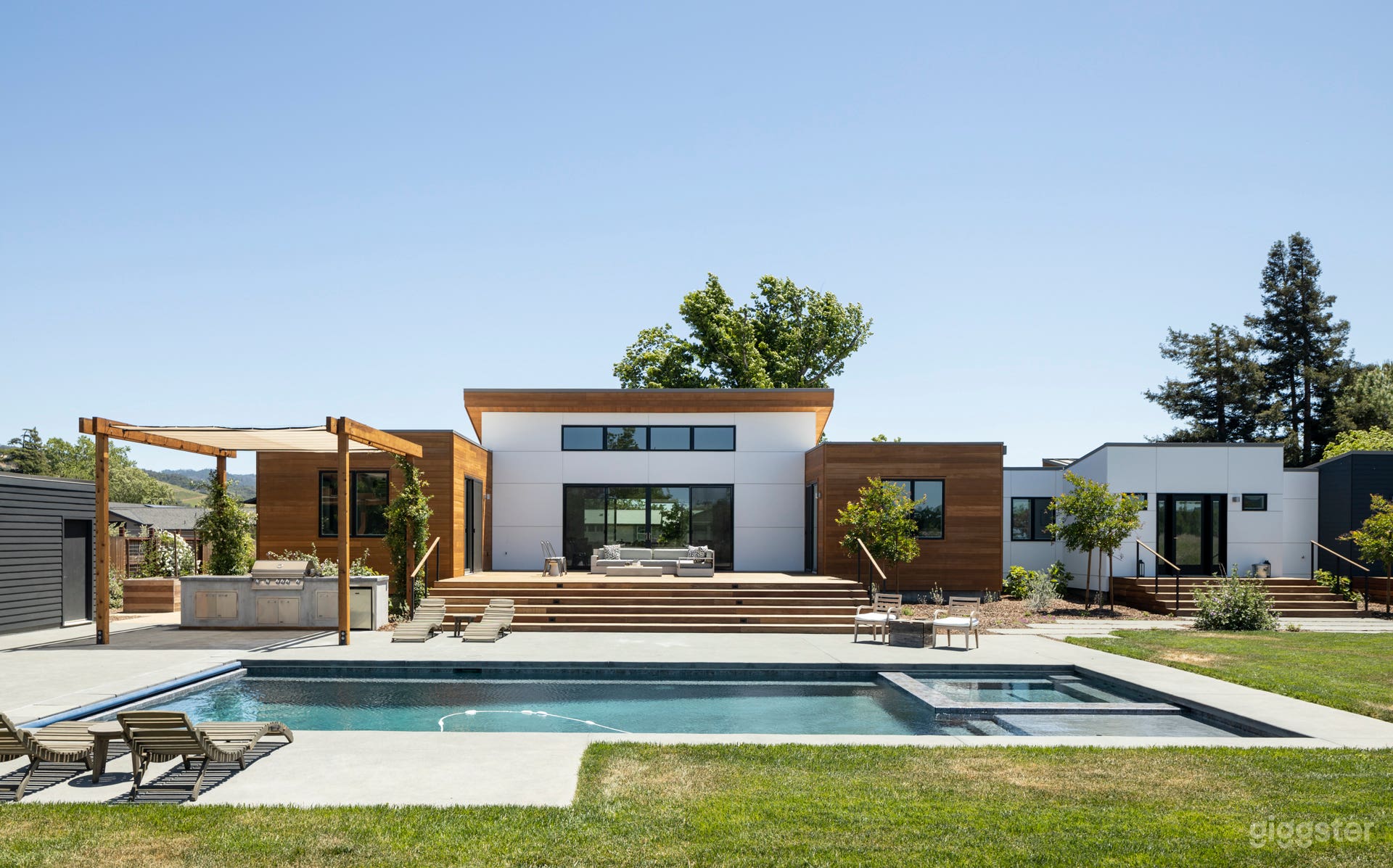 The spacious grounds feature comfortable seating around the pool and on the oversized deck overlooking vineyards.