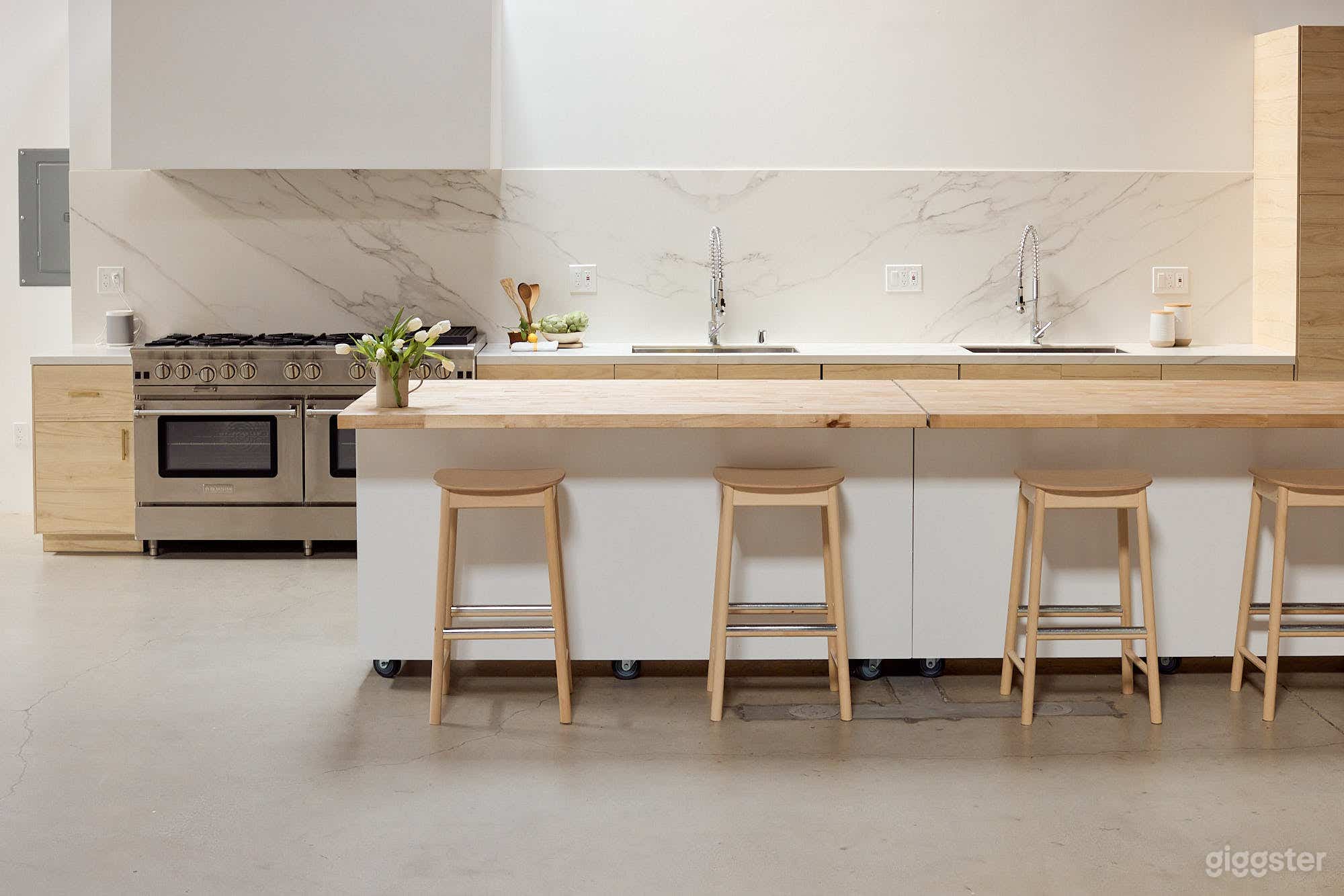 Gourmet prep kitchen designed by food stylists for food stylists. Equipped with a 60" commercial gas range, double oven, commercial refrigeration, two sinks and one dishwasher. Two rolling islands. This kitchen is also shootable.