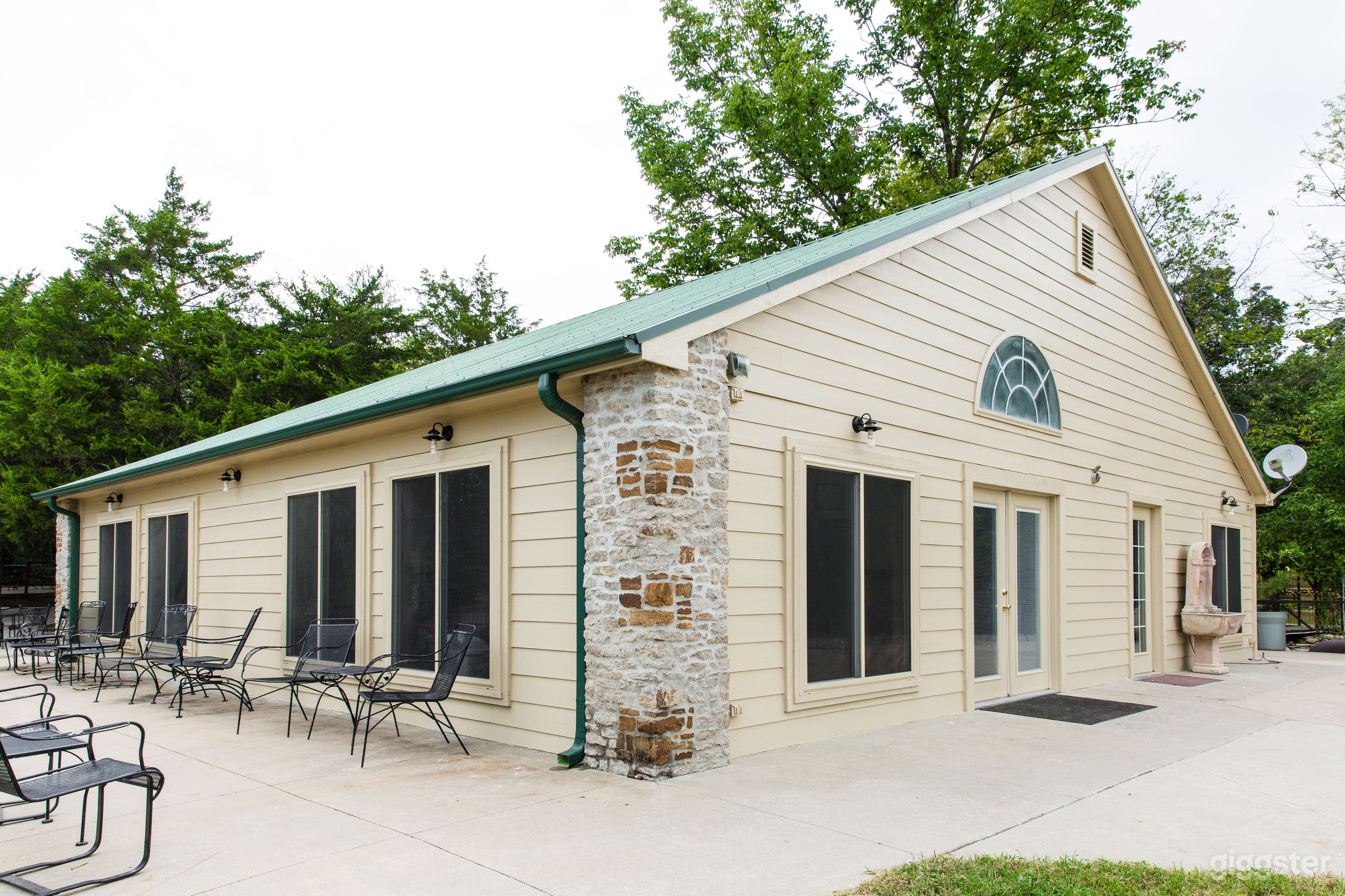 South &amp; East face of Lodge w/ patios on four sides, bridges &amp; waterfalls to right.