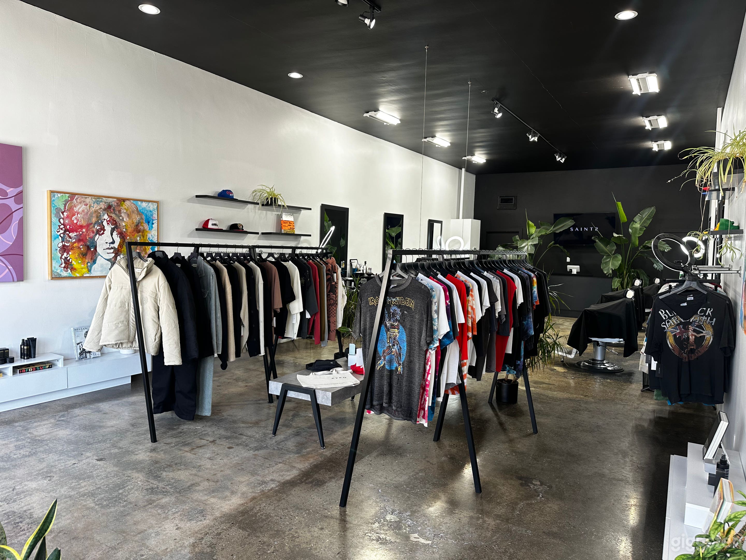 Wide shot of space. Black hanging racks are moveable.