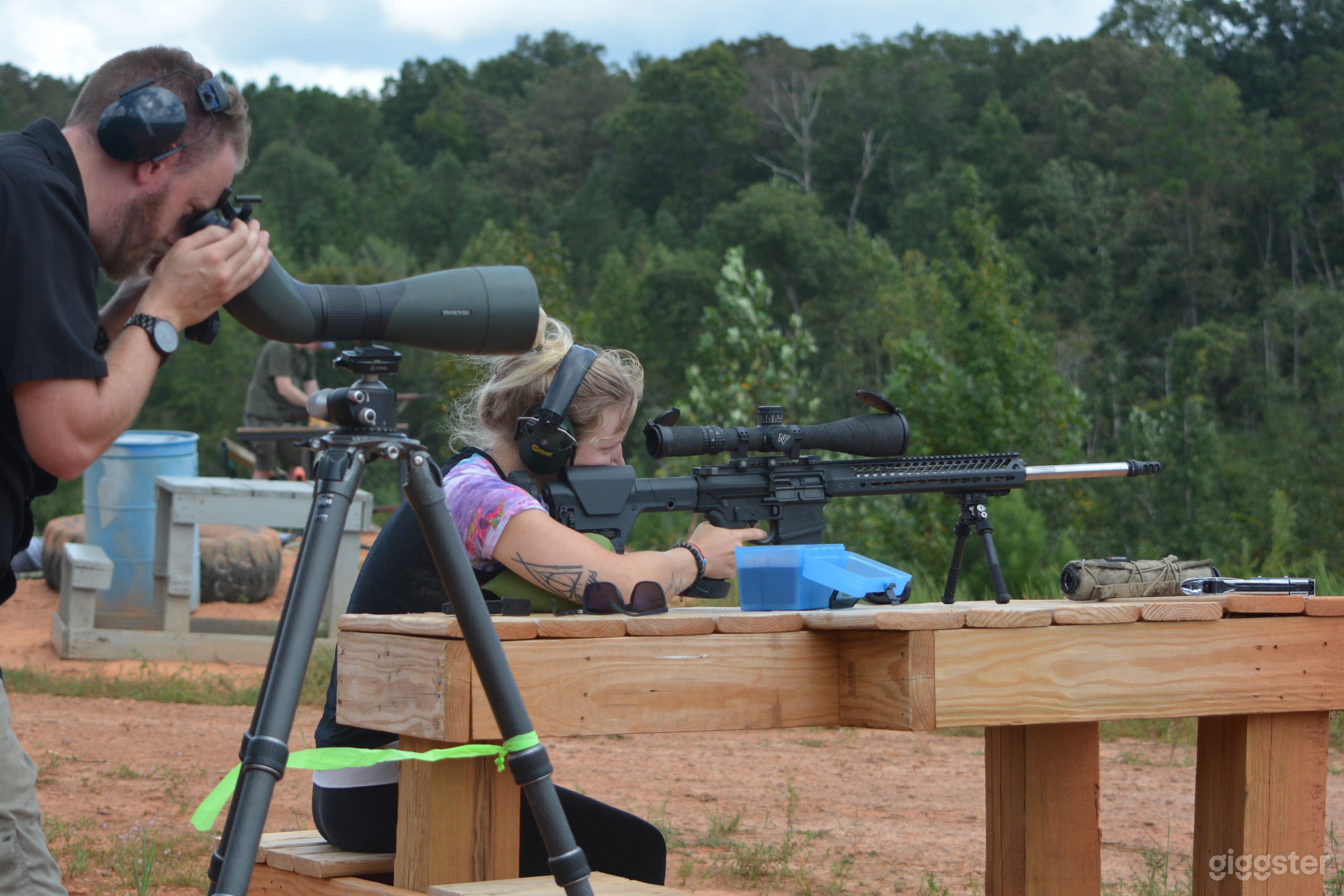 Couple shooting on the range. Firearms and support equipment can be supplied if needed. Including night vision thermal vision, tactical gear.
