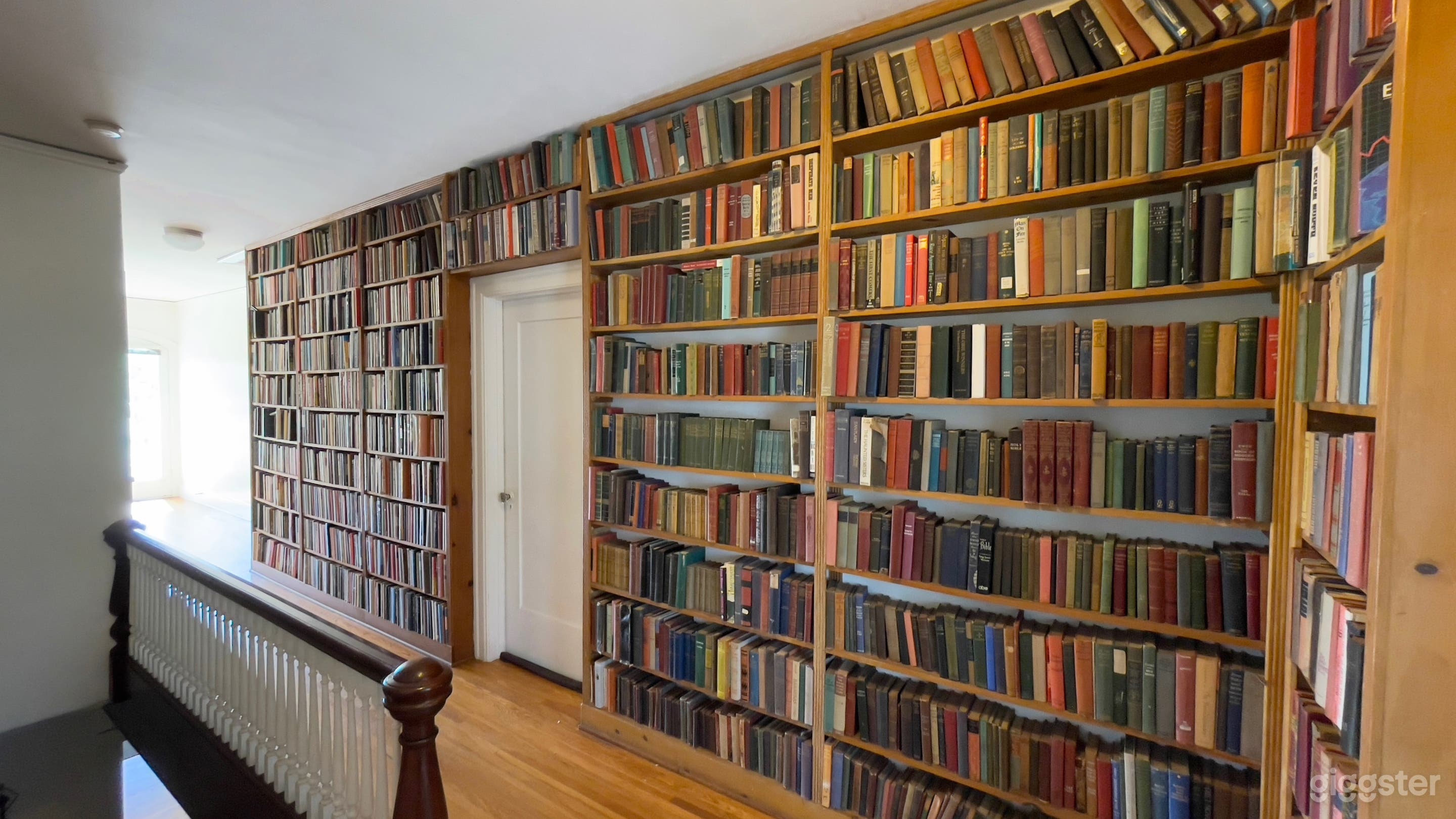 Unique bookshelves in large upstairs hallway.