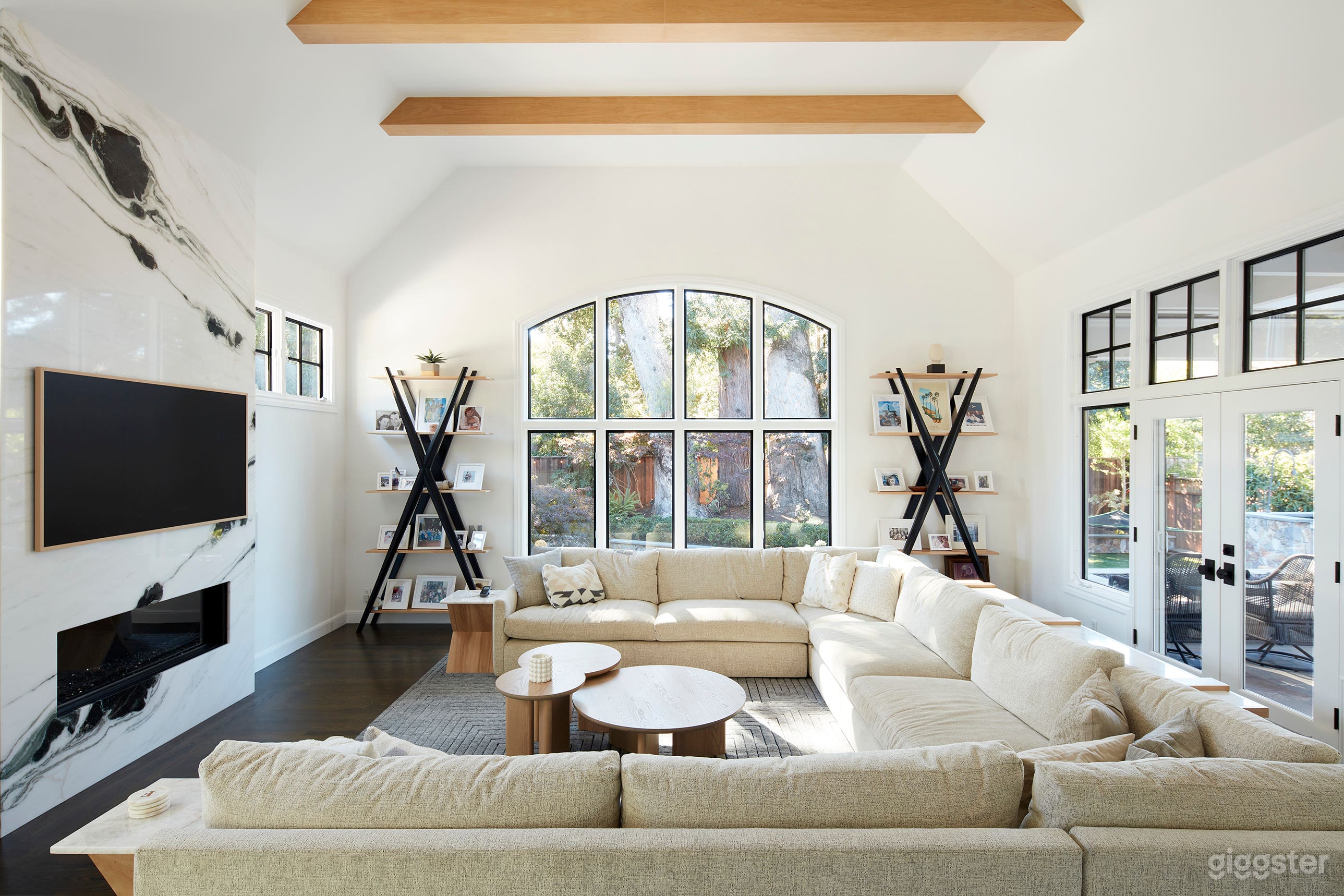 Sunken 20' x 20' living room with seating for 15 and views of backyard, pool and patio. Exposed beams and high ceilings