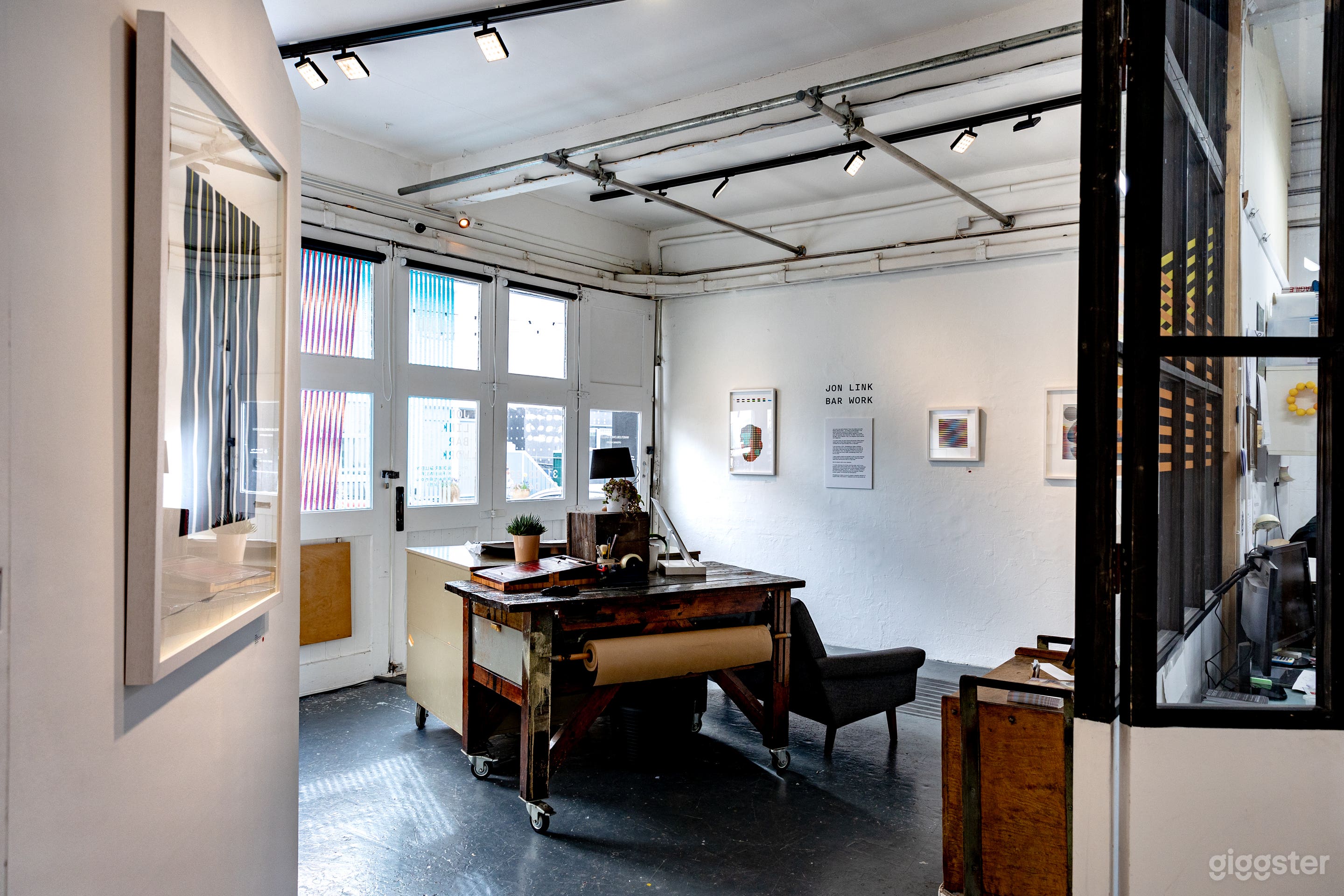 Atelier-style partition between the gallery and the print studio.