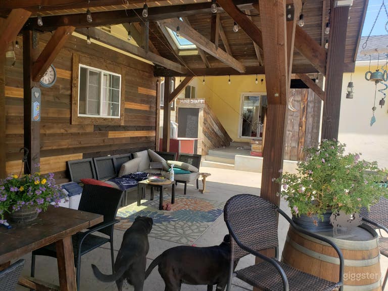  covered patio area with Out-house and basement in background 