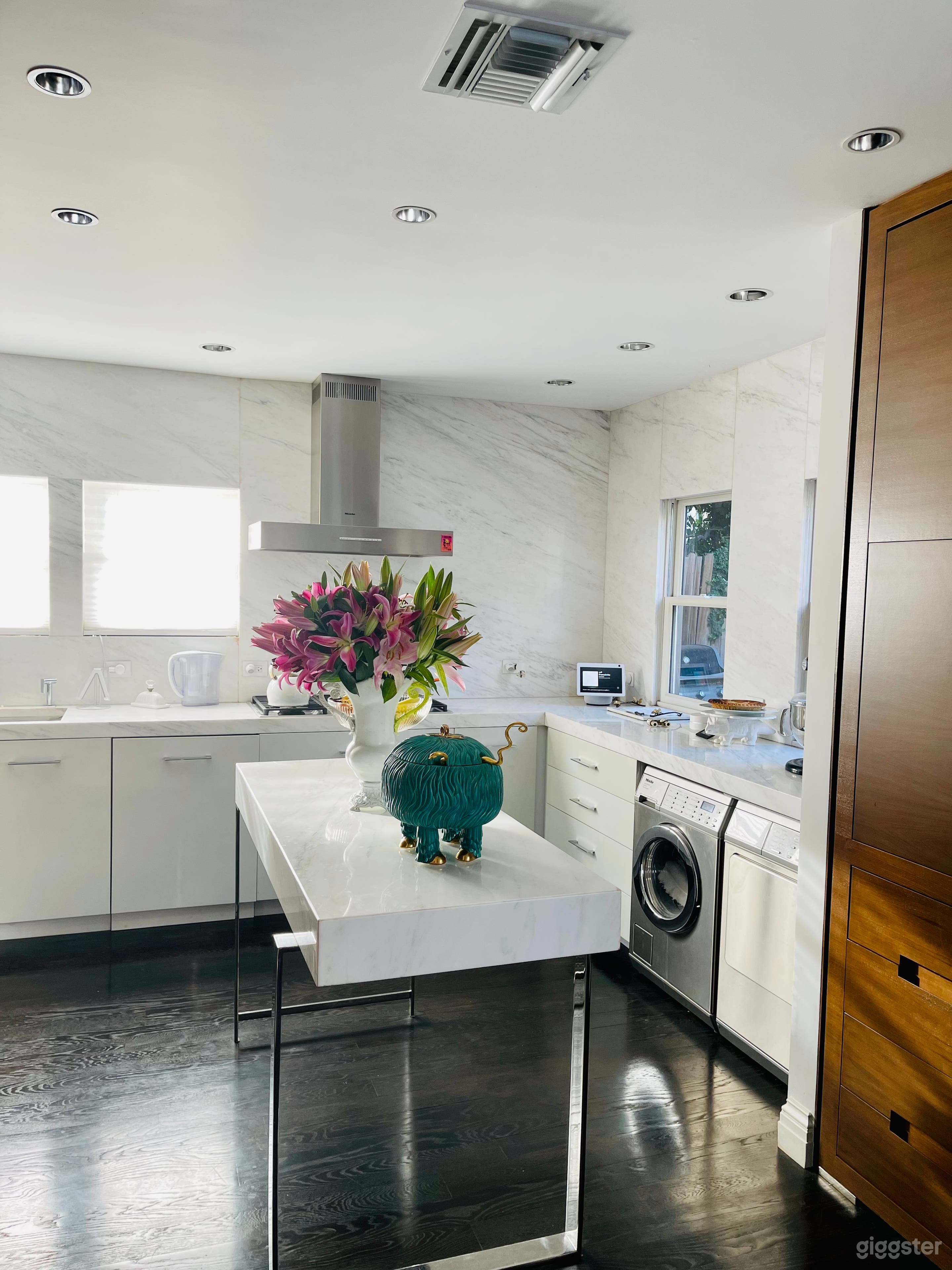 Kitchen with marble countertops and custom cabinets.