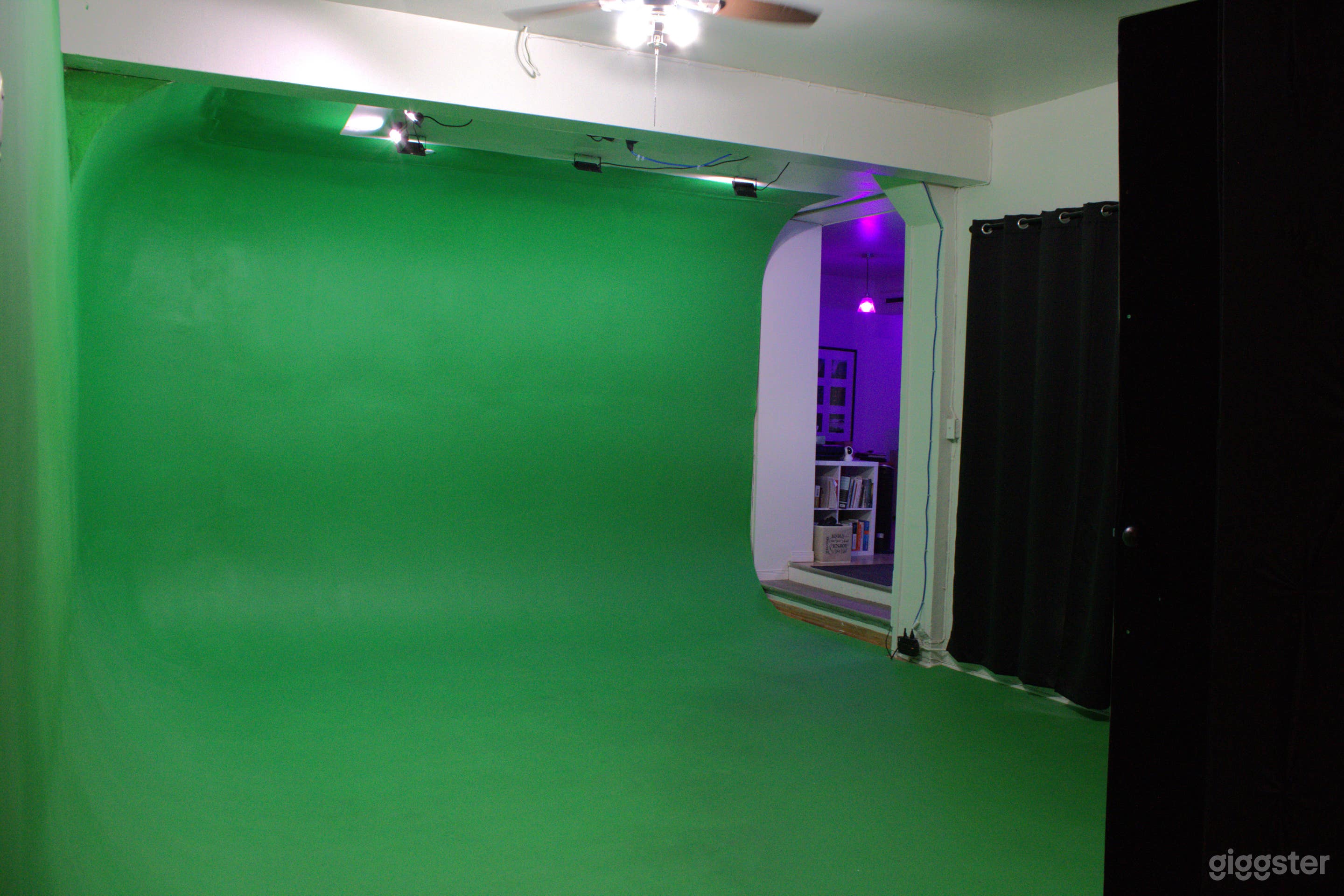 Green screen cyclorama with dedicated LED ceiling lighting and blackout curtains, leading to lounge area with app-controlled lighting