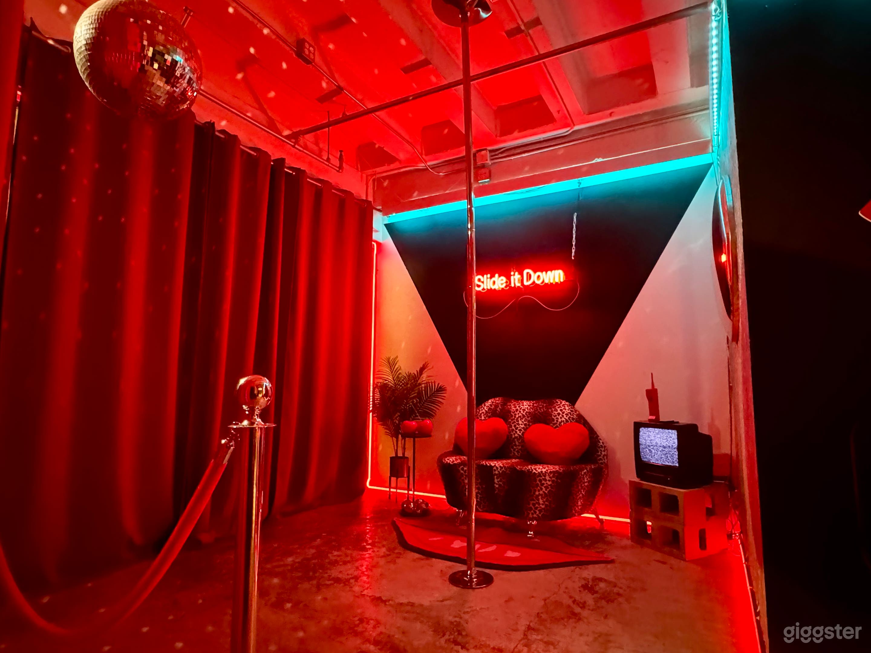 XOXO ROOM: Sexy and sassy, this room is bordered by red LED lights on the floor and ceiling, with a stripper pole as the centerpiece. Other key features include a leopard lips couch, LED wall, red velvet backdrop, zebra print wallpaper and neon signs