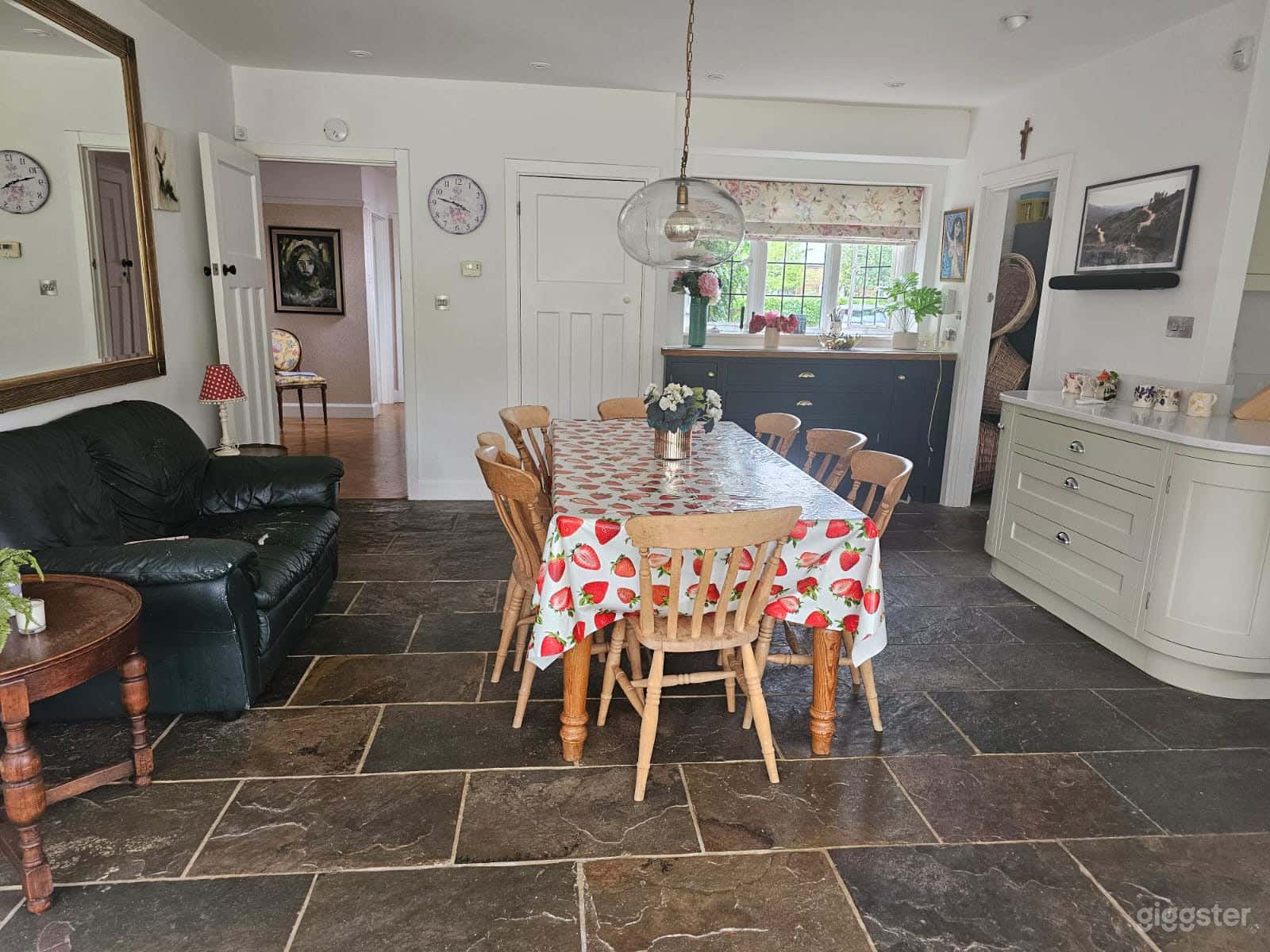 The rustic stone flooring and vibrant table setting evoke cozy family gatherings or intimate dinner moments—ideal for storytelling, food shoots, or seasonal campaigns.