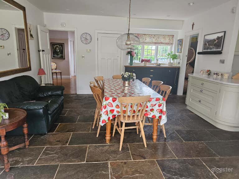  The rustic stone flooring and vibrant table setting evoke cozy family gatherings or intimate dinner moments—ideal for storytelling, food shoots, or seasonal campaigns. 