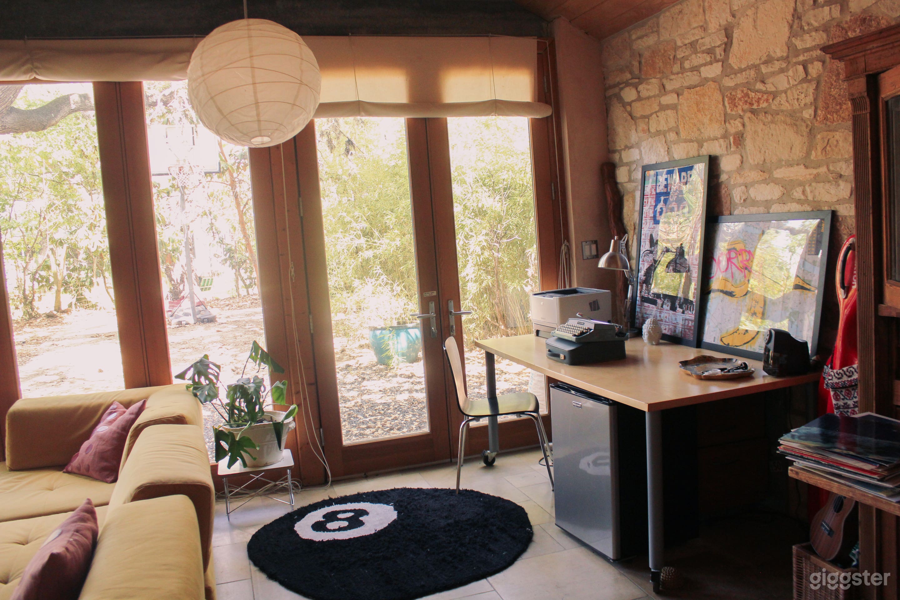 office corner, floor to ceiling windows, stone walls 