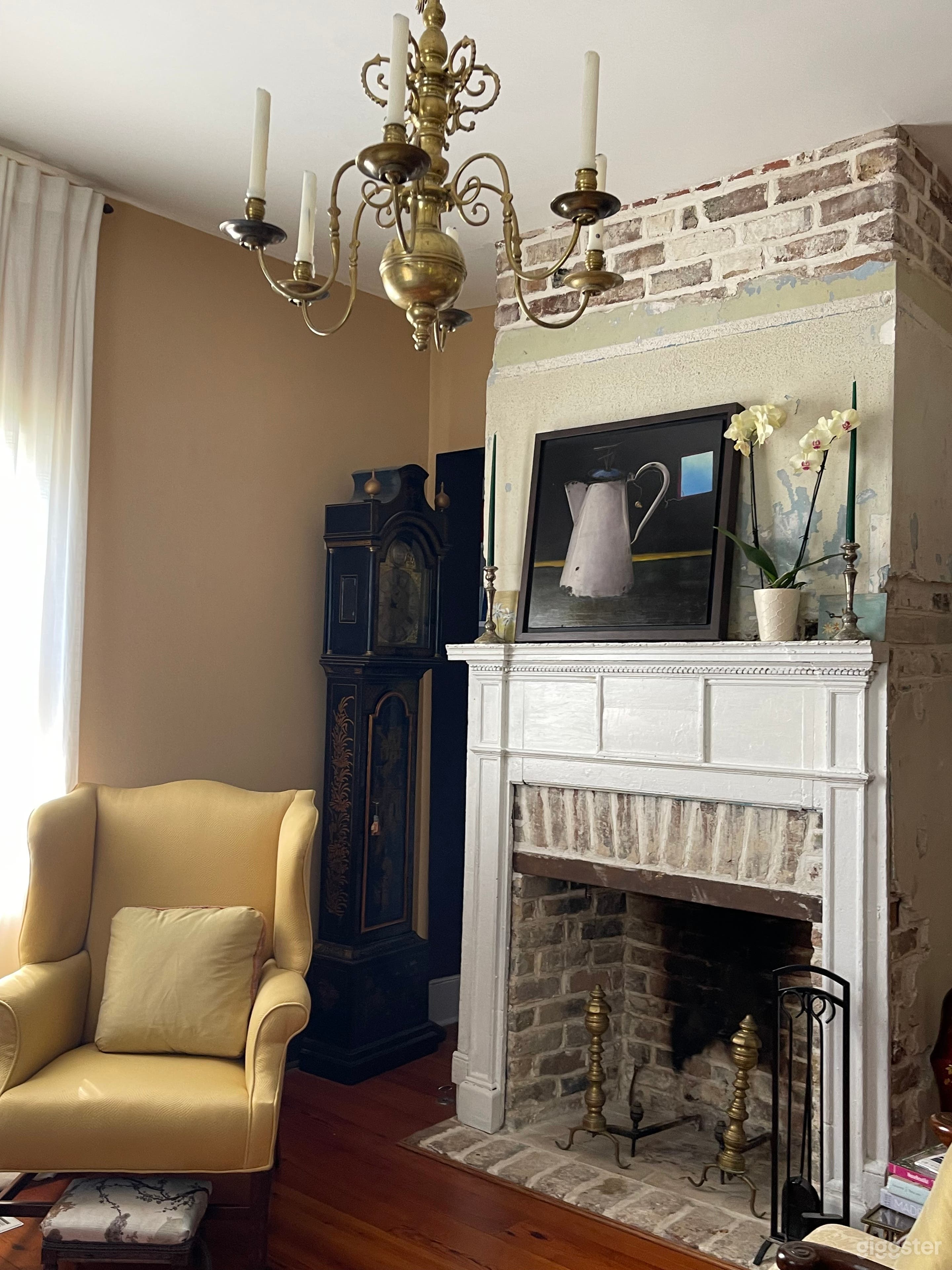Living room with exposed brick and federal-period mantel. 
