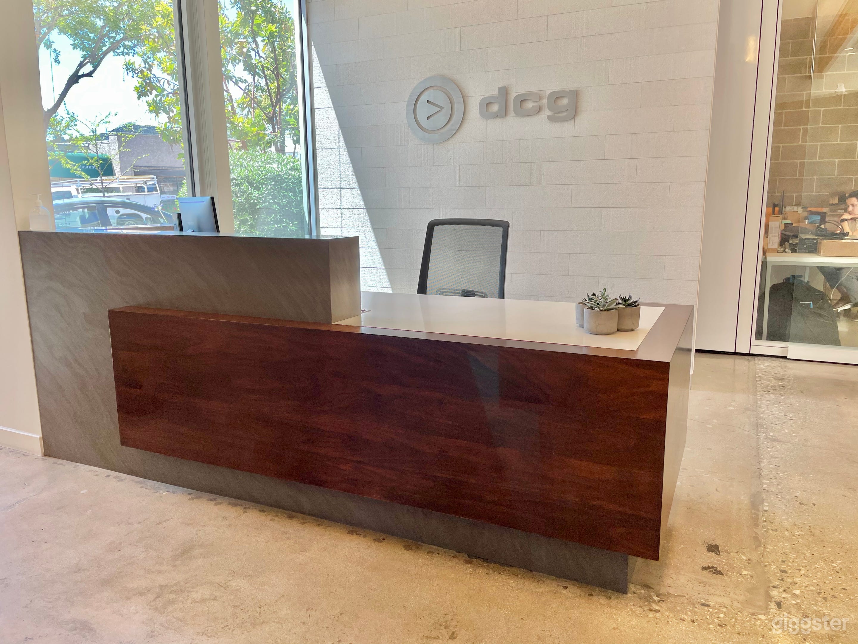Significant front desk area with large white stone wall for logos and branding.