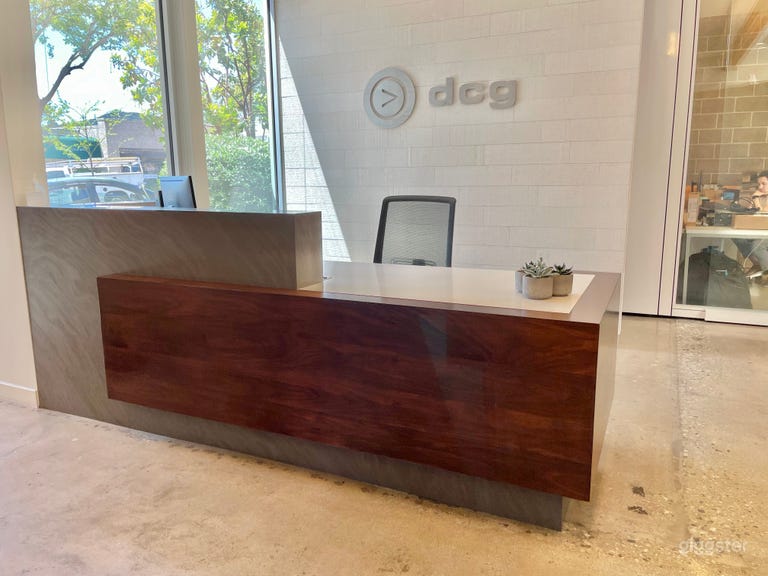  Significant front desk area with large white stone wall for logos and branding. 