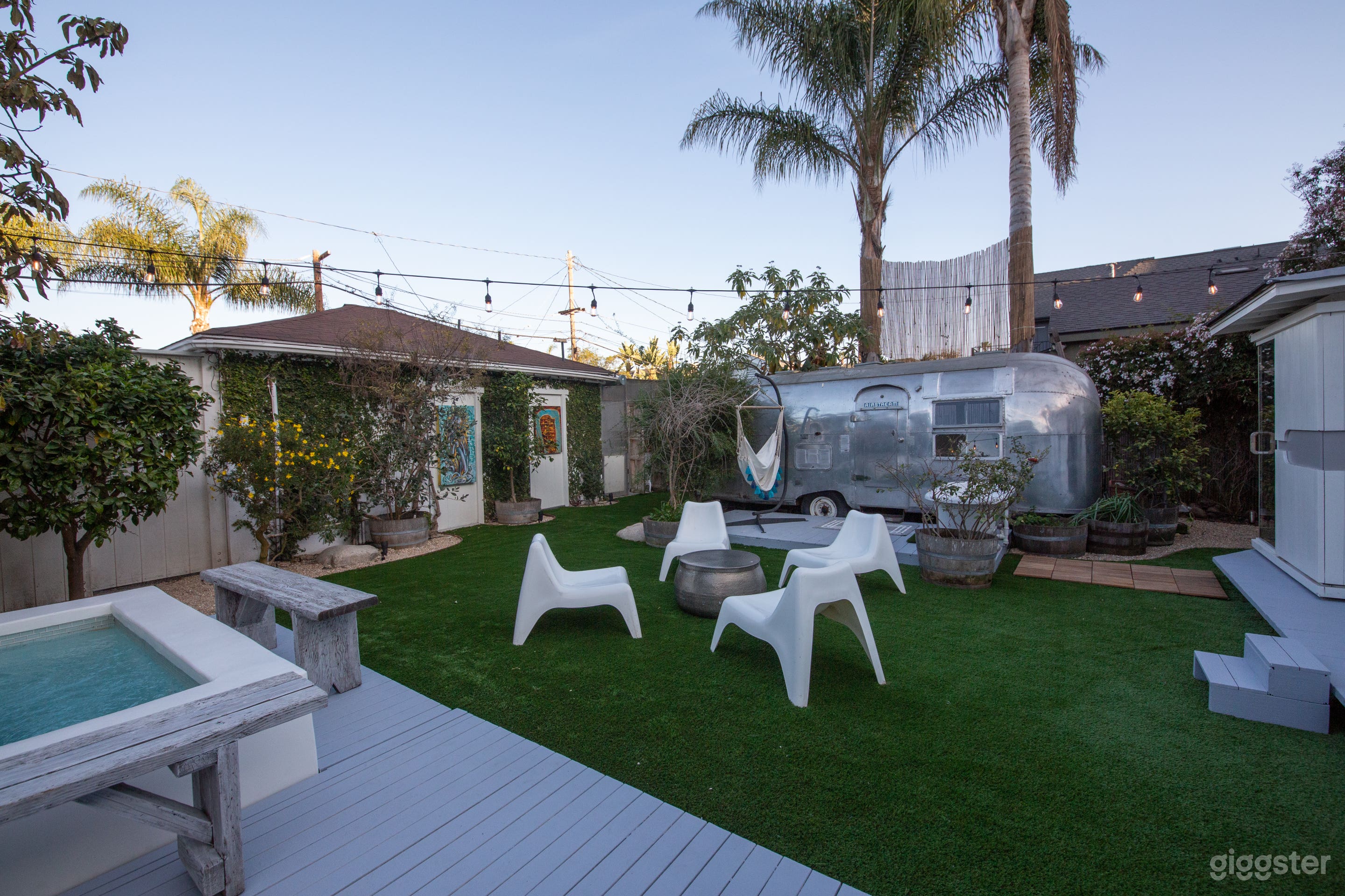 Soak up the sun amidst lush greenery and fruit trees in the backyard