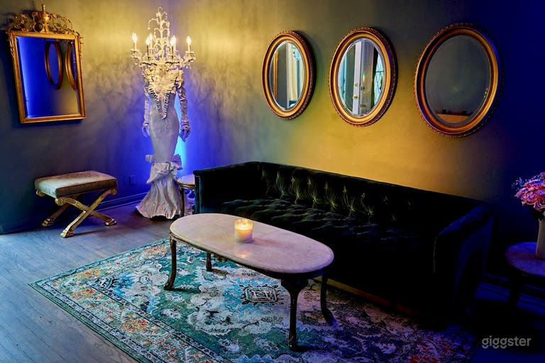  This Parisian themed room with lounge seating and fanciful decor leads to the outdoor garden. 