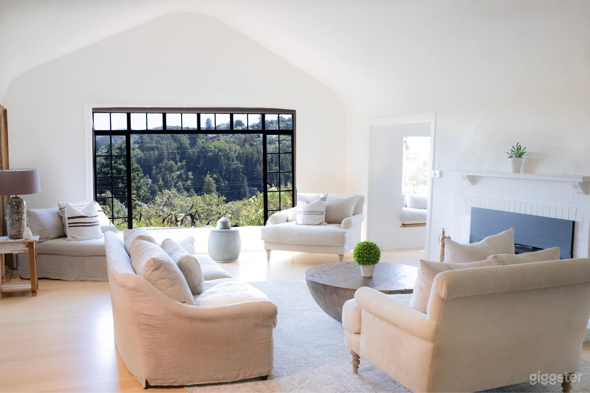 Spacious living room, gorgeous high ceilings, fireplace, wide plank harwood flooring throughout home, and views