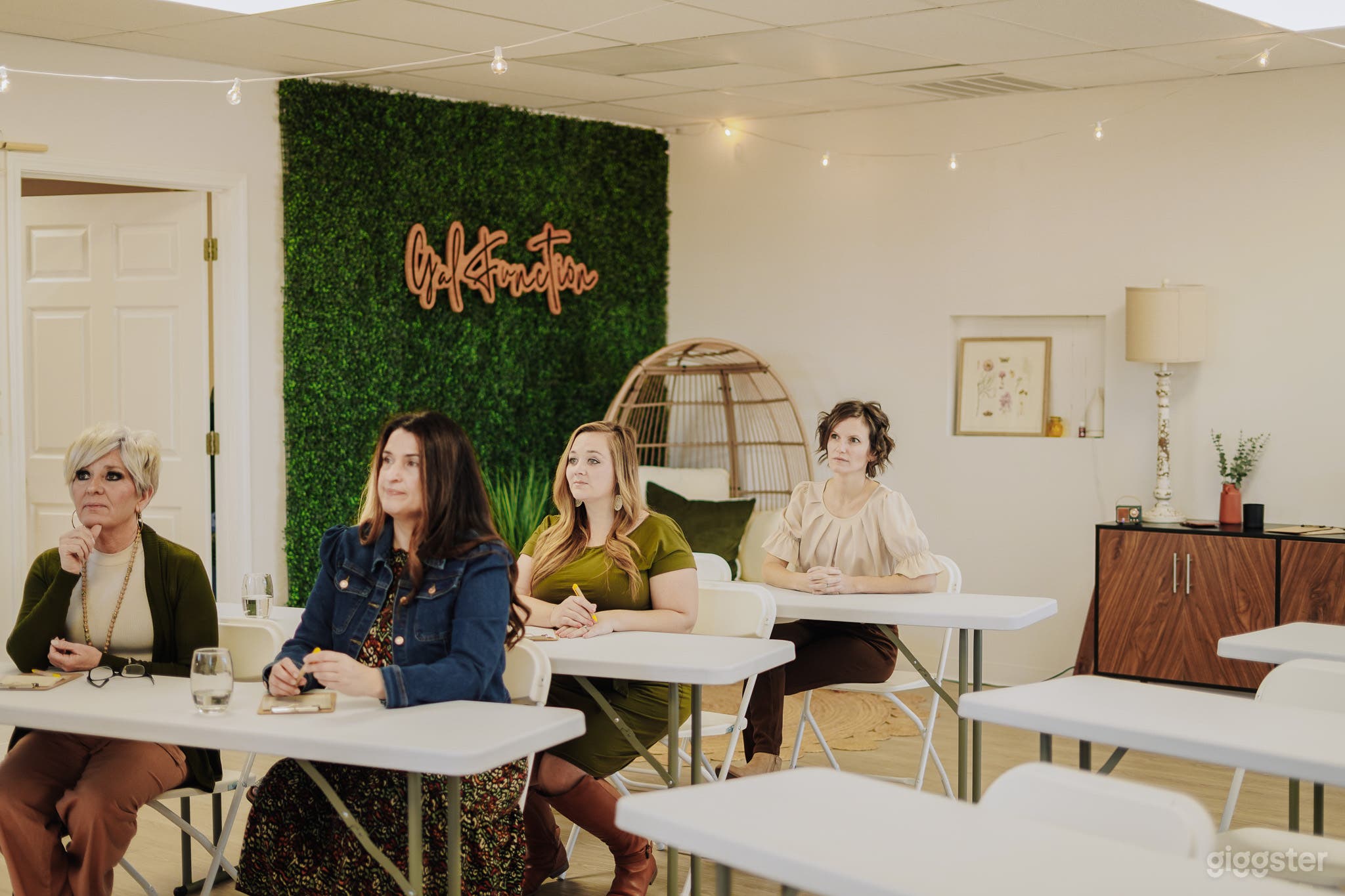 Greenery backdrop. Egg chair.