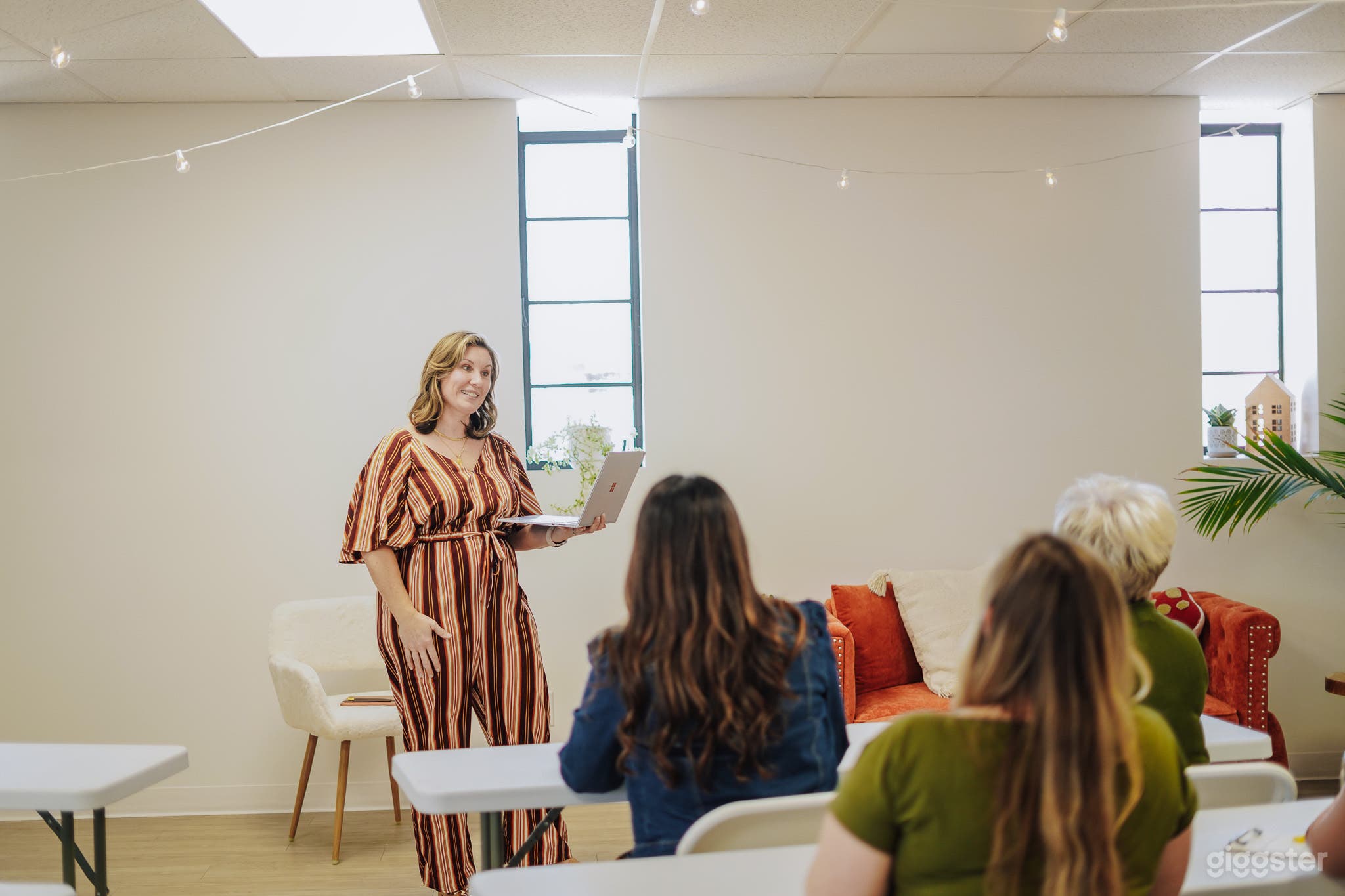 Natural Light. Tables and chairs available. White walls.