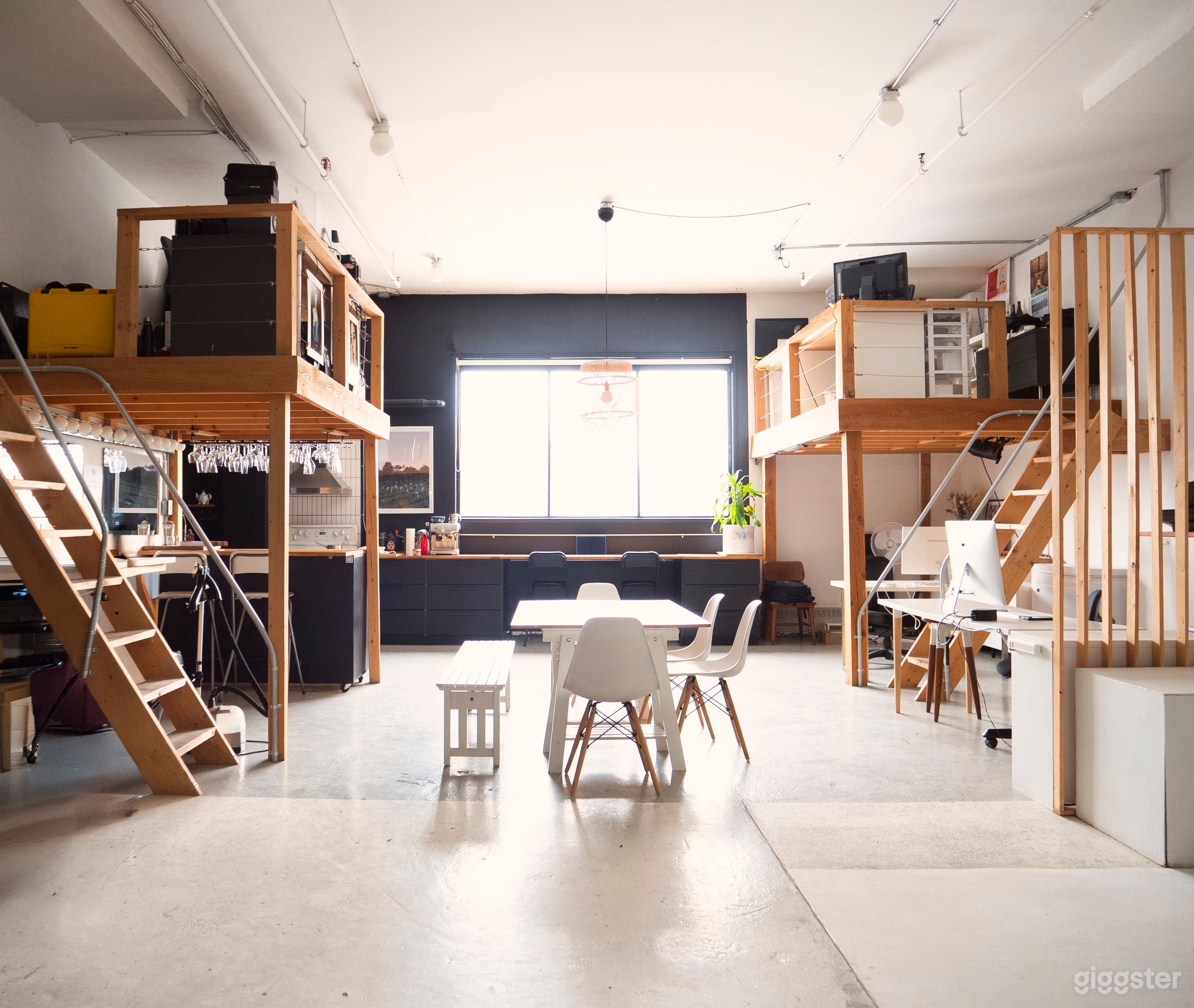 Featuring a large panoramic window with blackout curtains for versatile lighting, 12-foot ceilings for an airy feel, and a kitchen with a dining area. The dining table can be moved for shoots, making it perfect for capturing natural light.