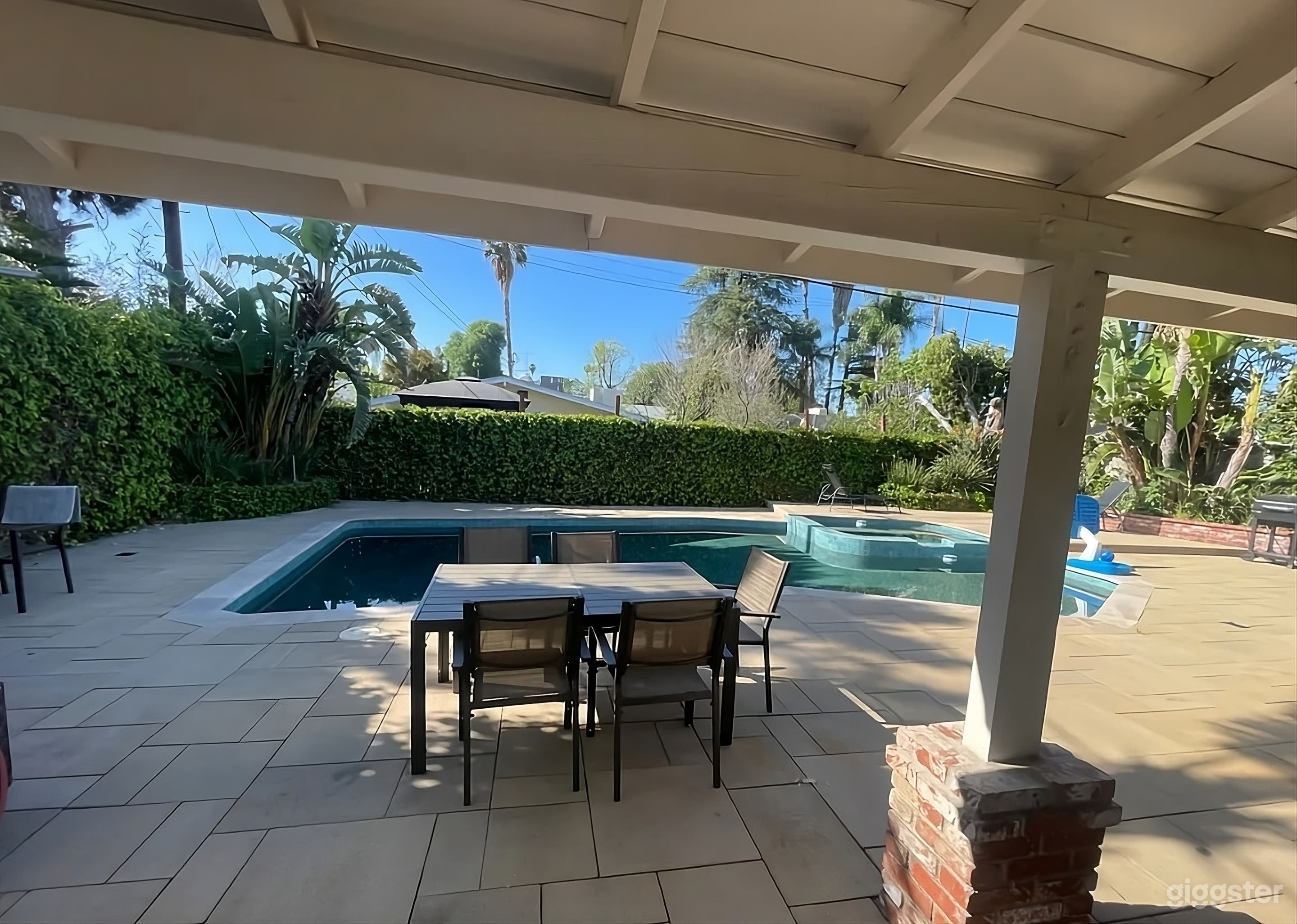 Lush Backyard with Pool and Game Area Photo 1