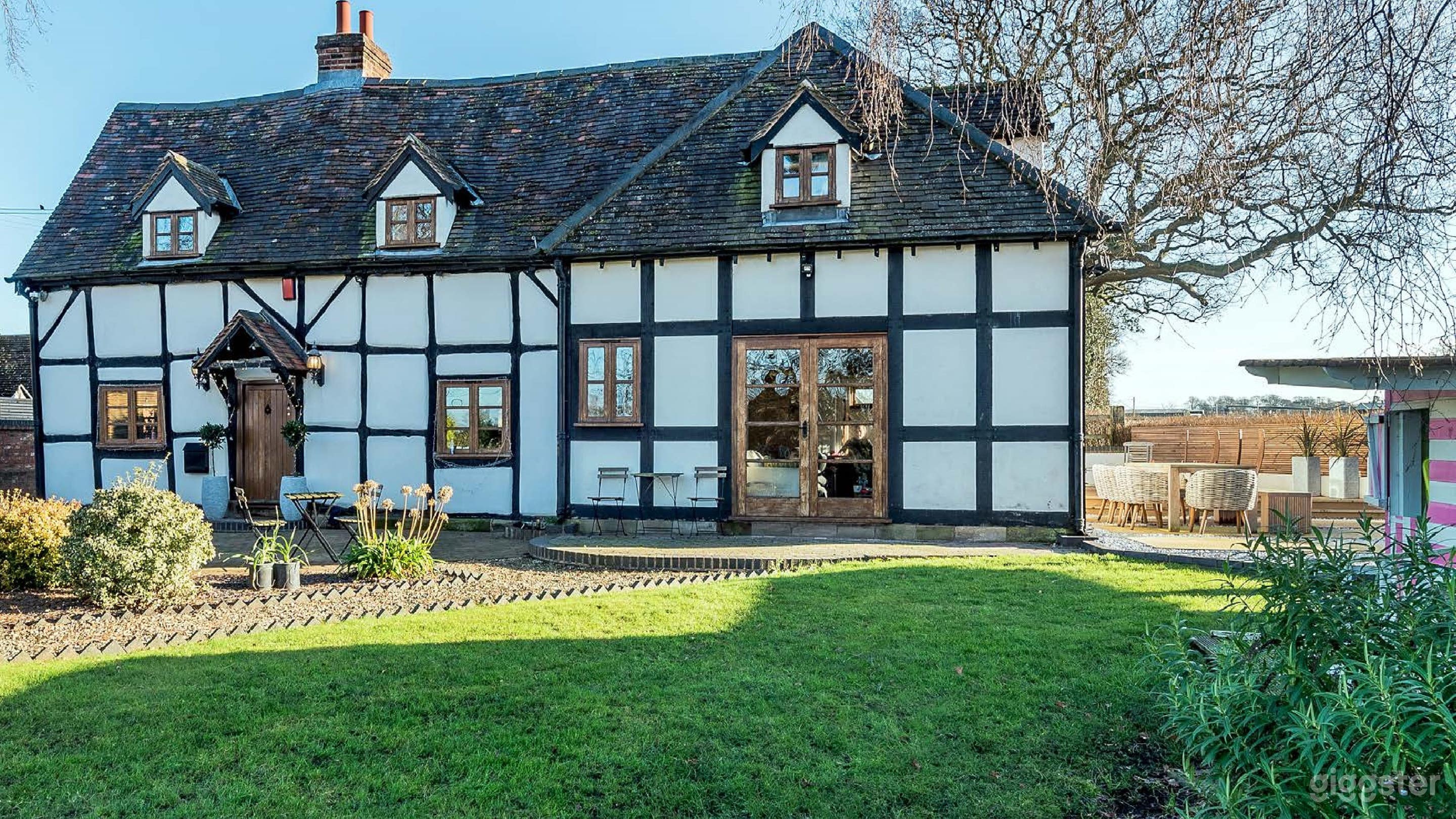 Looking at the front of the property, standing within the front garden. 
