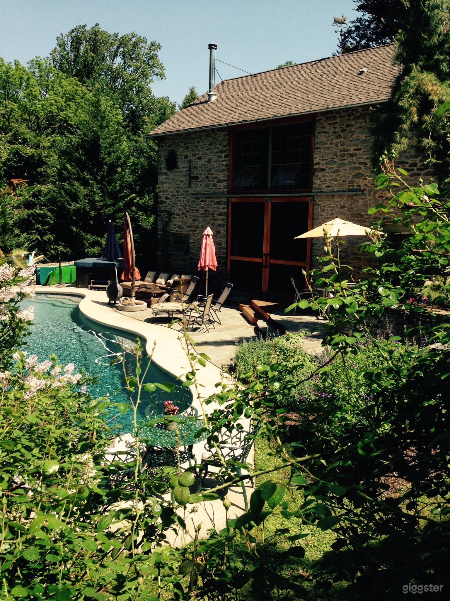 View of pool and outside of stone barn