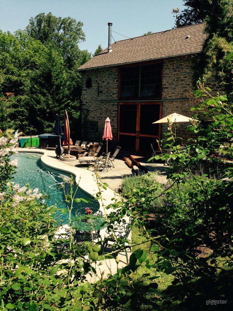  View of pool and outside of stone barn 