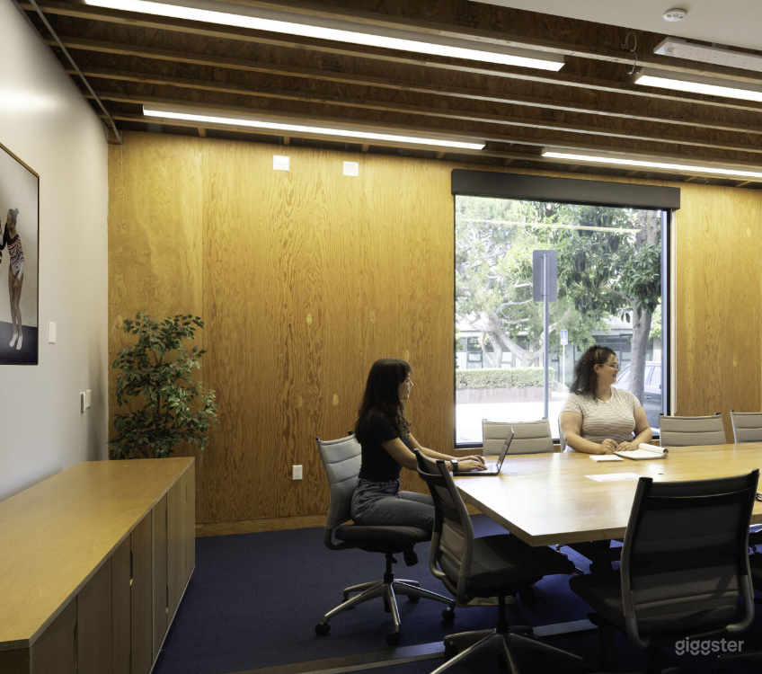 Large Conference Room with large tv, exterior and interior windows and a creative vibe